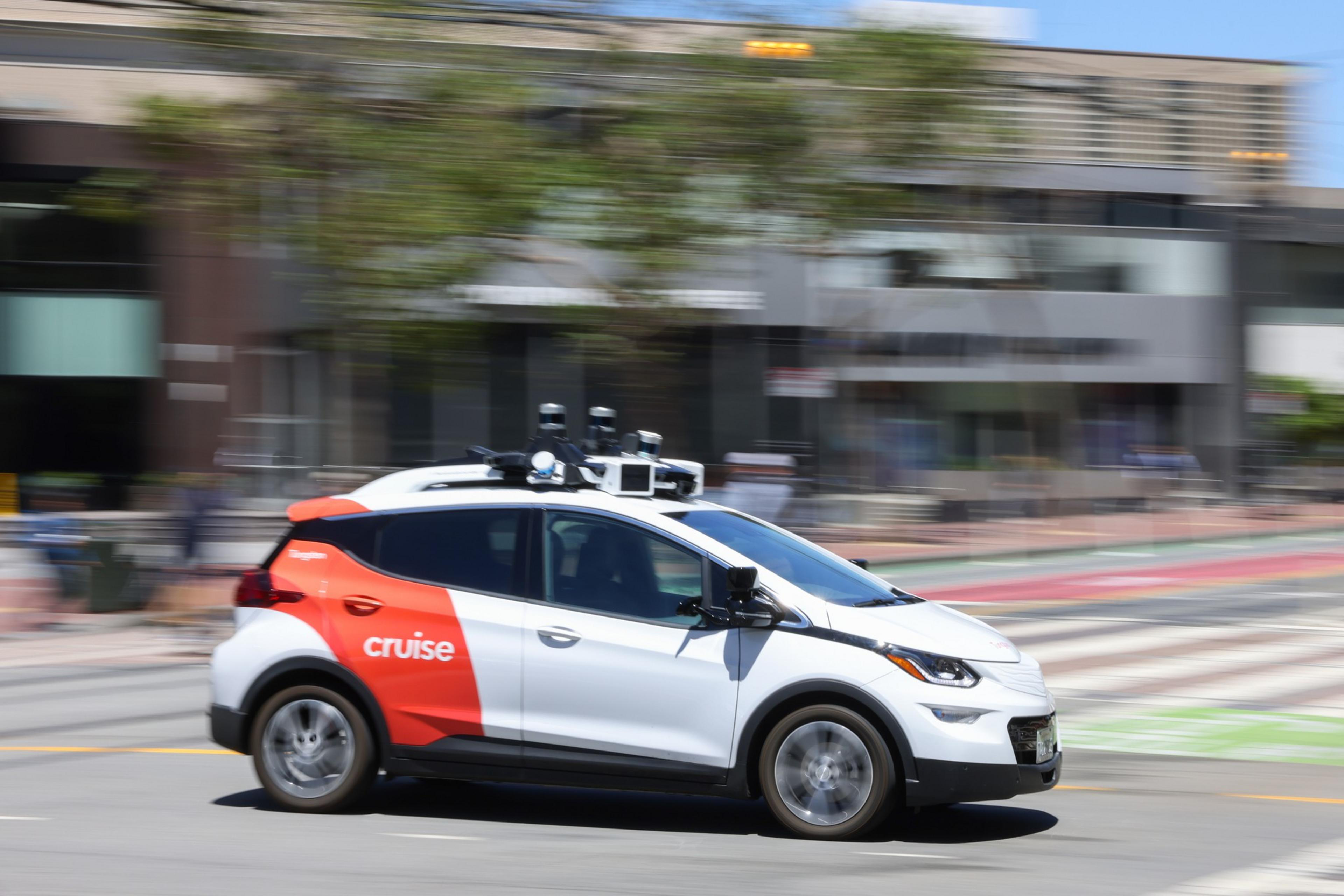 A Cruise car drives along Market Street in San Francisco.