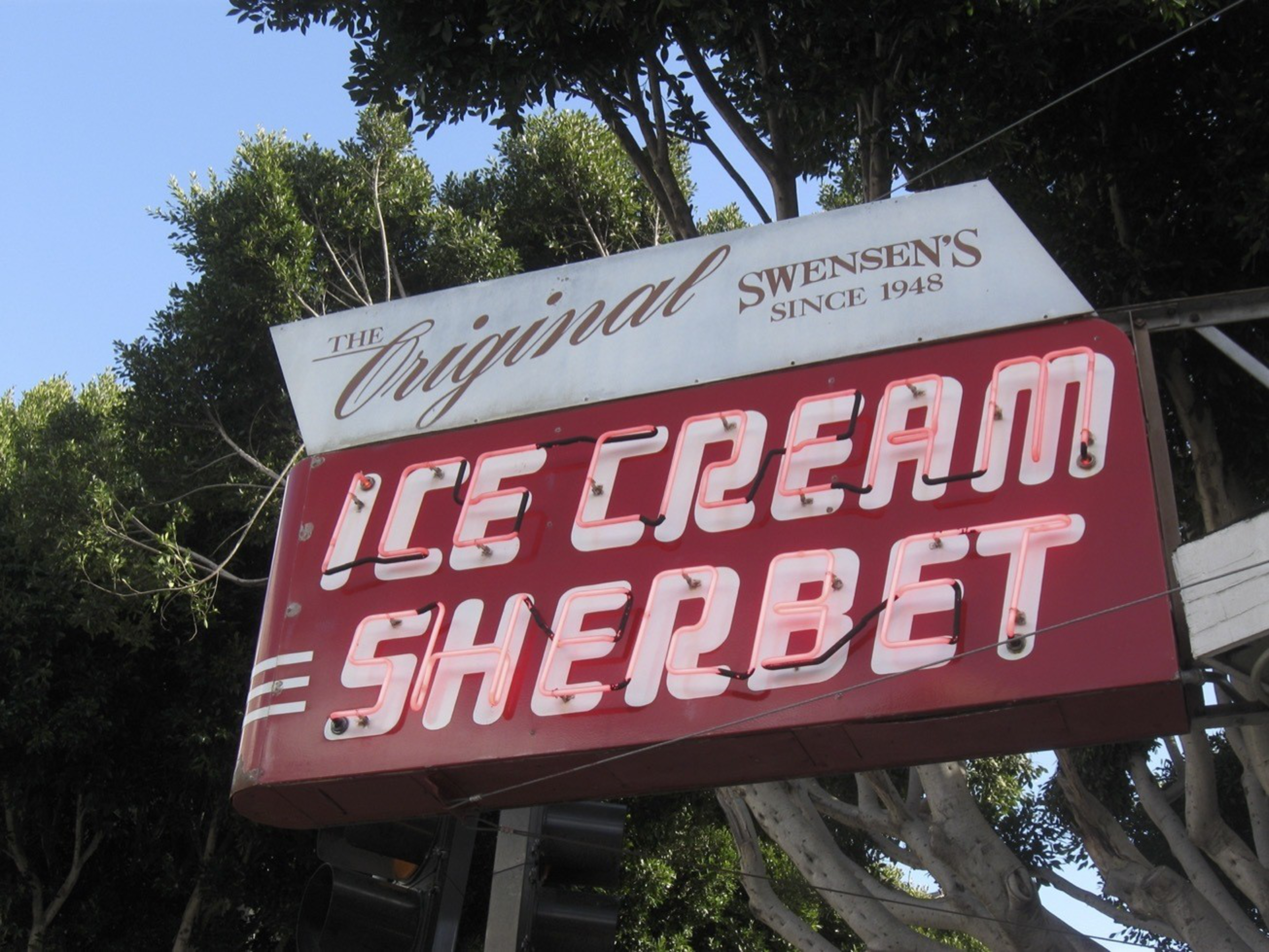 A vintage neon sign reads "The Original Swensen's Since 1948" and highlights "Ice Cream Sherbet" in bright pink neon letters against a red background.