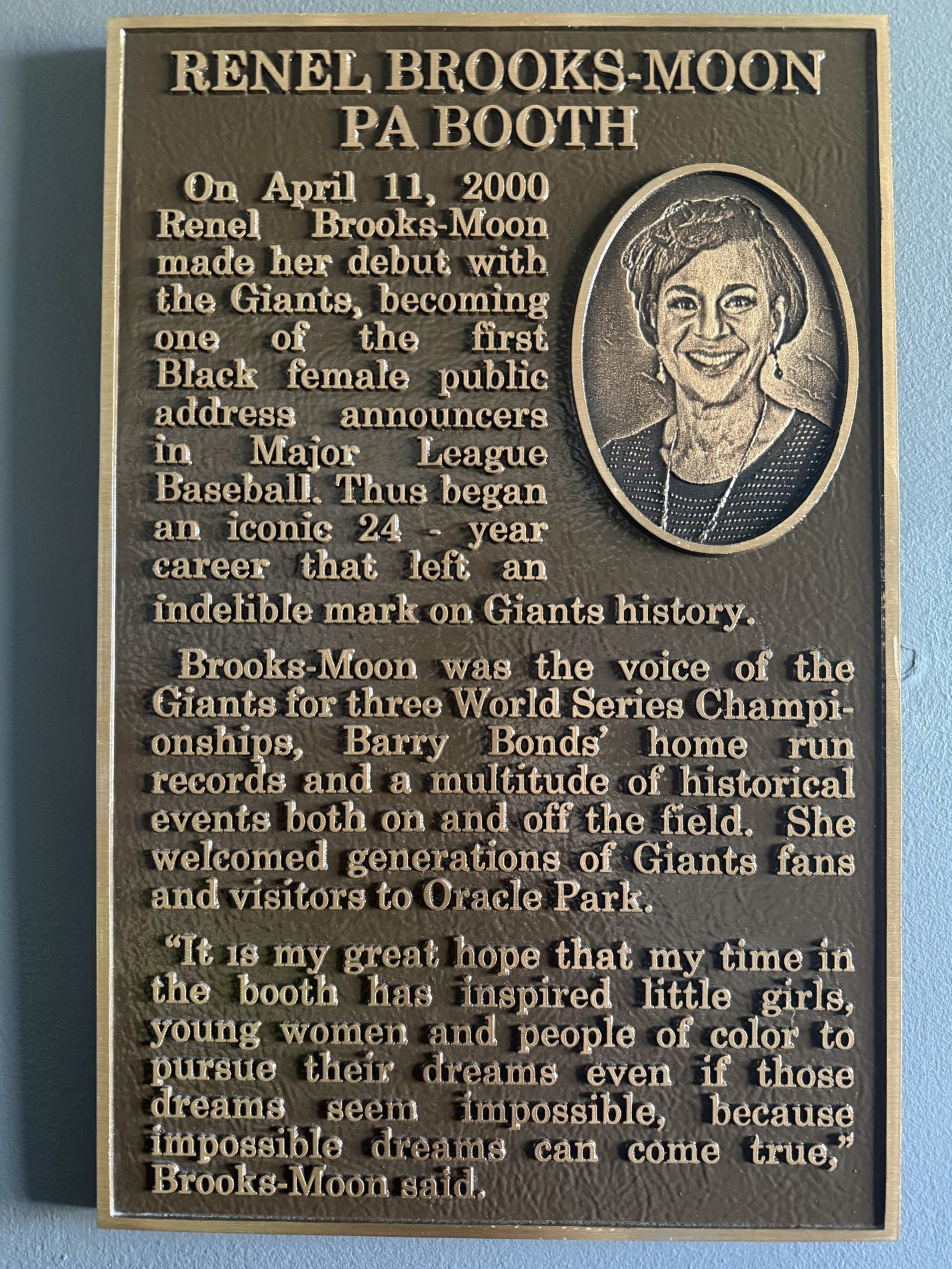 This plaque honors Renel Brooks-Moon, a pioneering Black female MLB announcer for the Giants, celebrating her 24-year career and inspiring future generations.