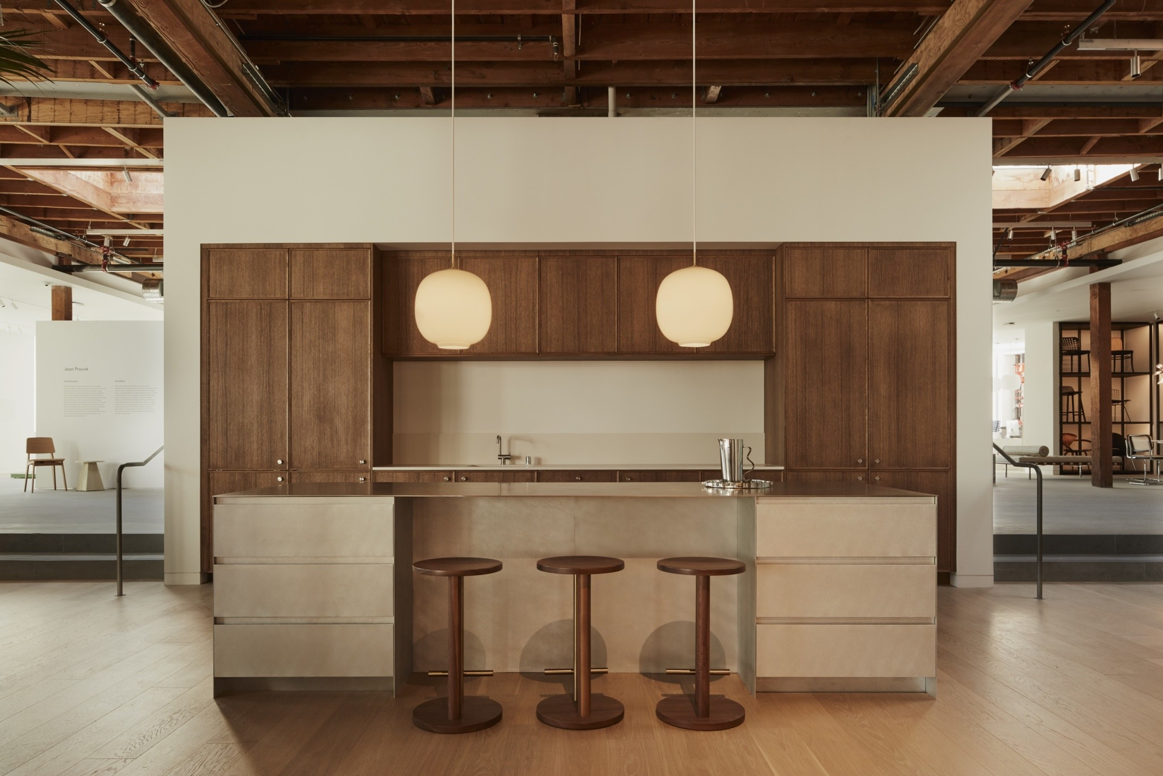 Wooden cabinetry lines the back of a sample kitchen in a Design Within Reach furniture store in San Francisco.