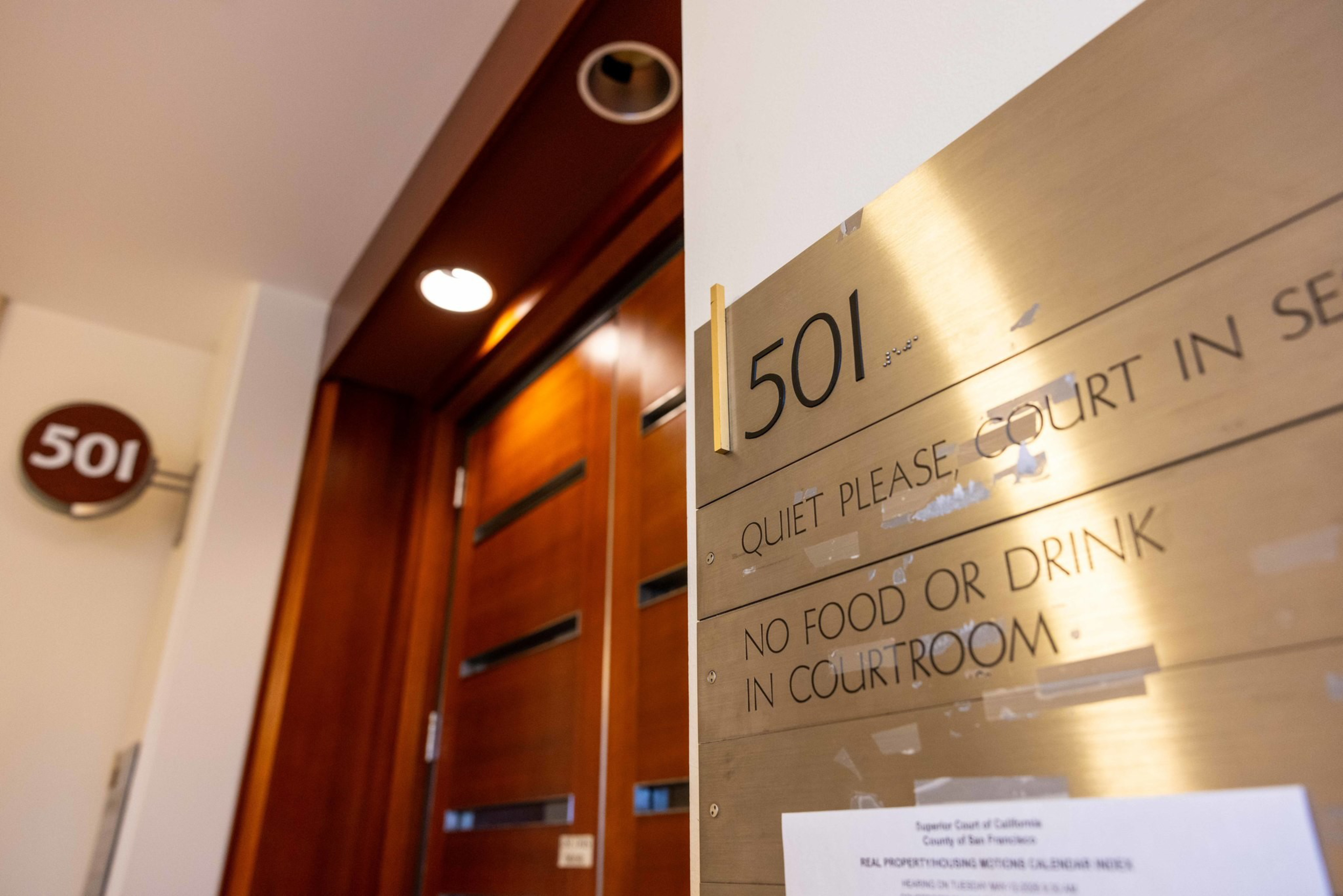Room number 501 with a wooden door and a brass sign warning “Quiet please, court in session” and “No food or drink in courtroom.”