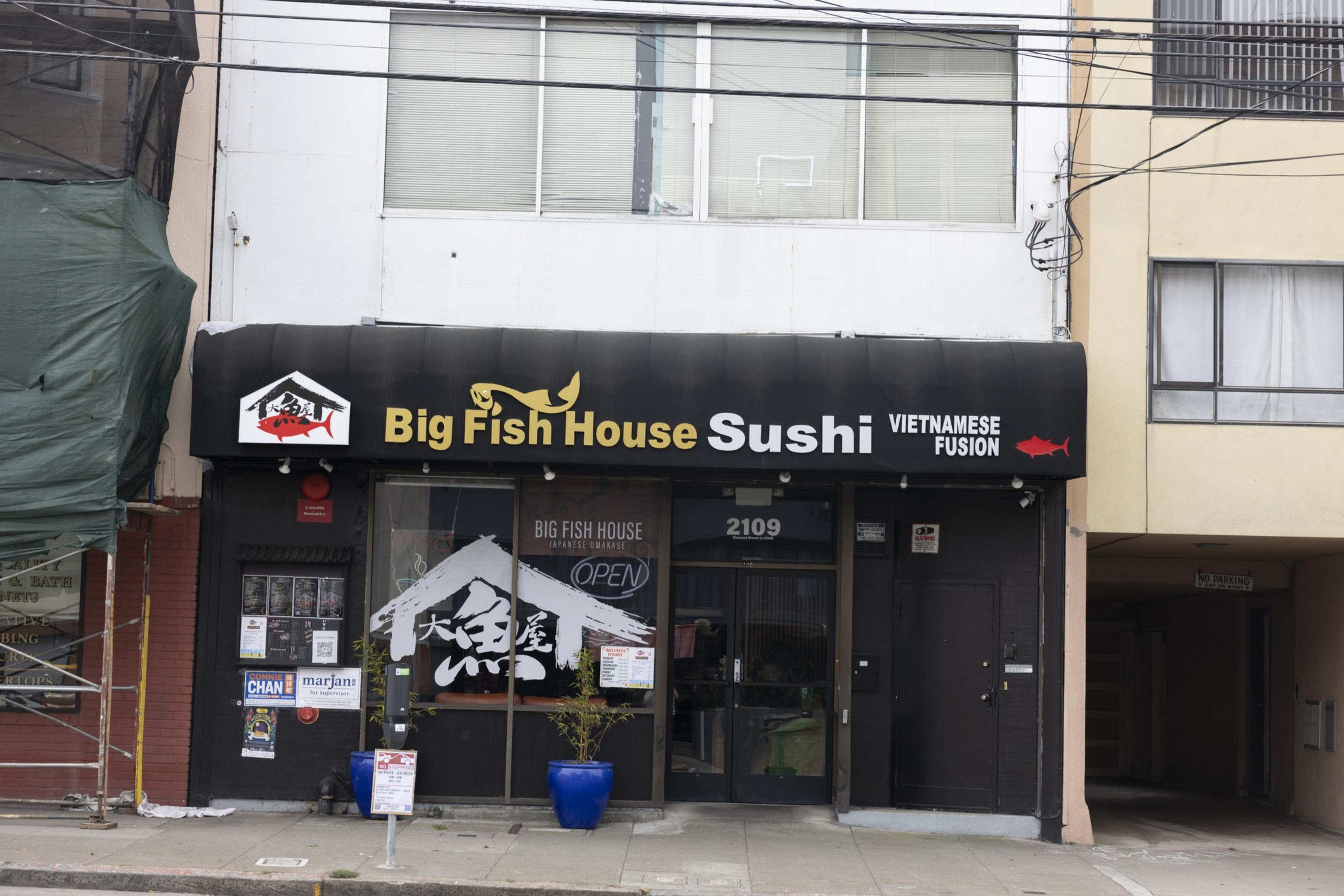 The image shows a storefront with a sign reading &quot;Big Fish House Sushi Vietnamese Fusion&quot; with a black awning. The building's address is 2109.