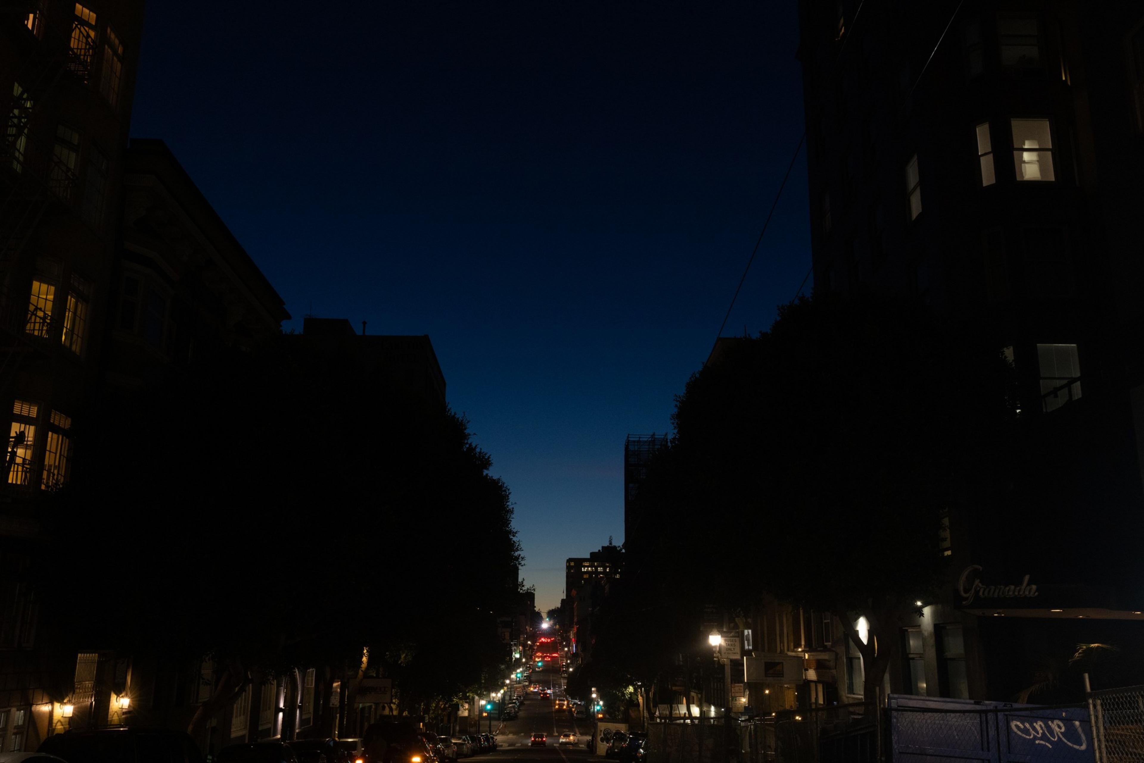 As night sets in San Francisco, the street of Sutter is illuminated by city and apartment lights. 
