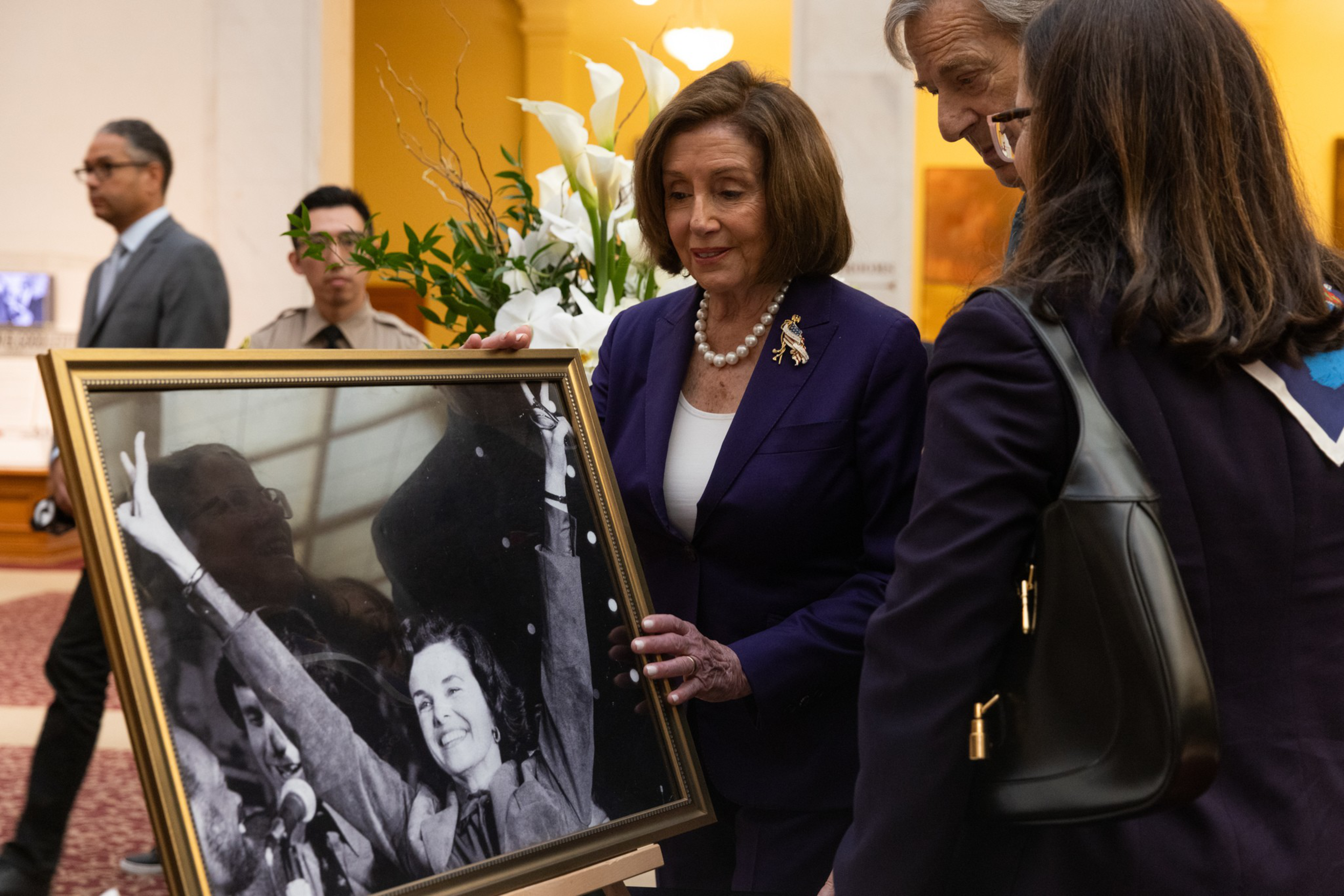 United States Representative Nancy Pelosi holds a picture of United States Senator Dianne Feinstein at a condolence book signing for the senator at City Hall in San Francisco on Wednesday, Oct. 4, 2023. City Hall was open to the public Wednesday for individuals to pay their respects as Senator Feinstein lied in state. Feinstein died at 90.