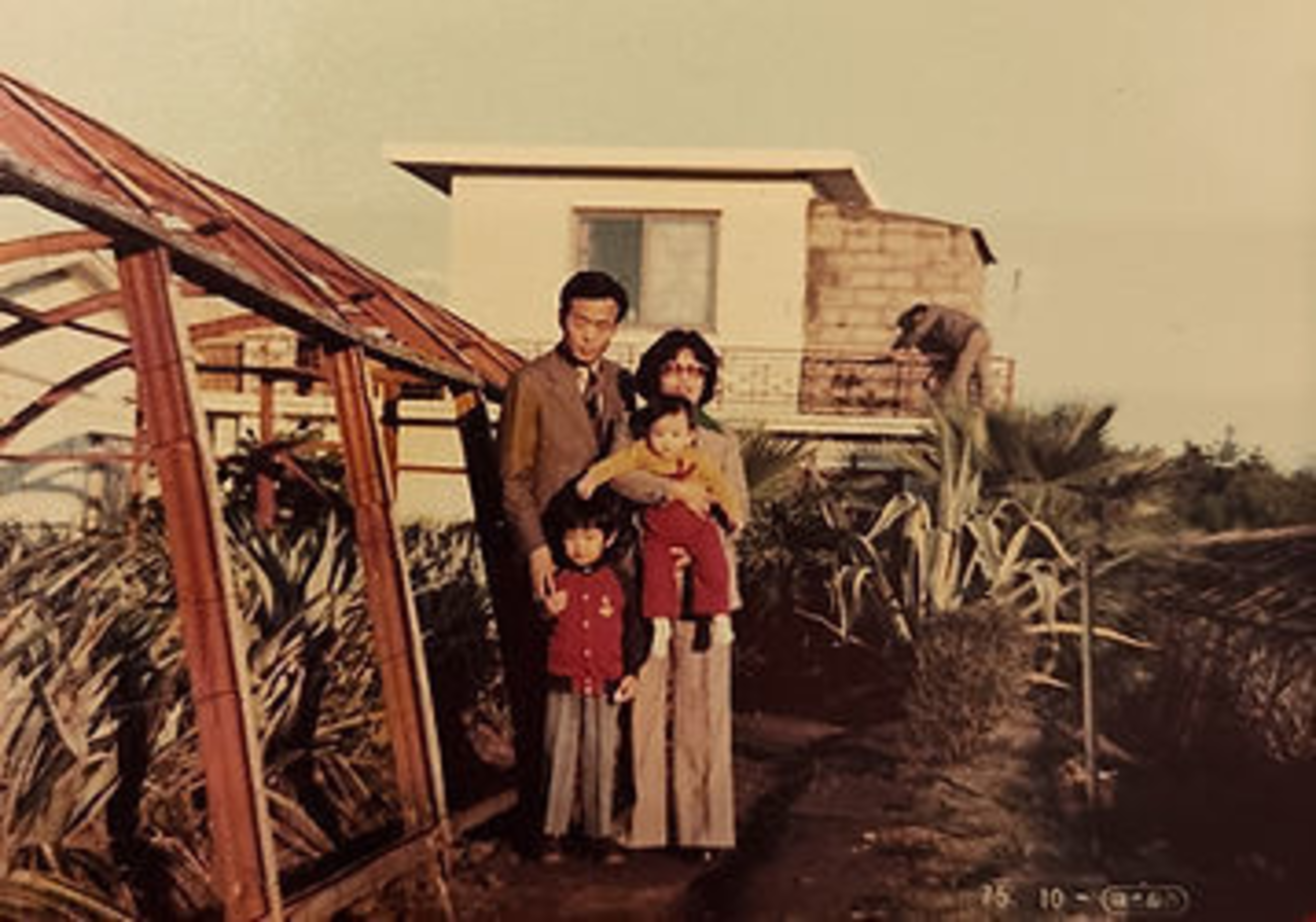 A family stands for a portrait. 