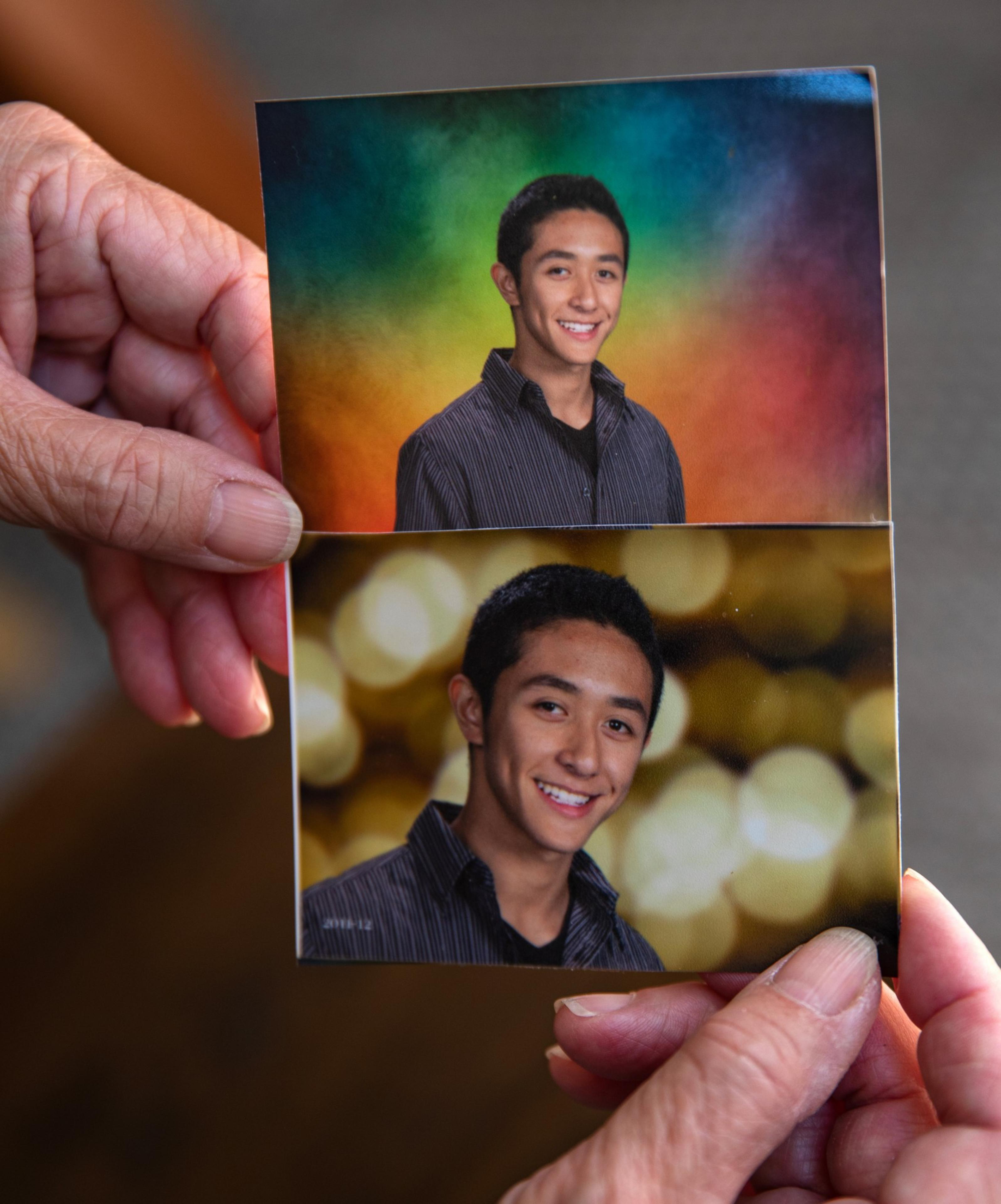Two hands hold two photos of a smiling young man in a striped shirt, with one photo overlaid partially on the other.