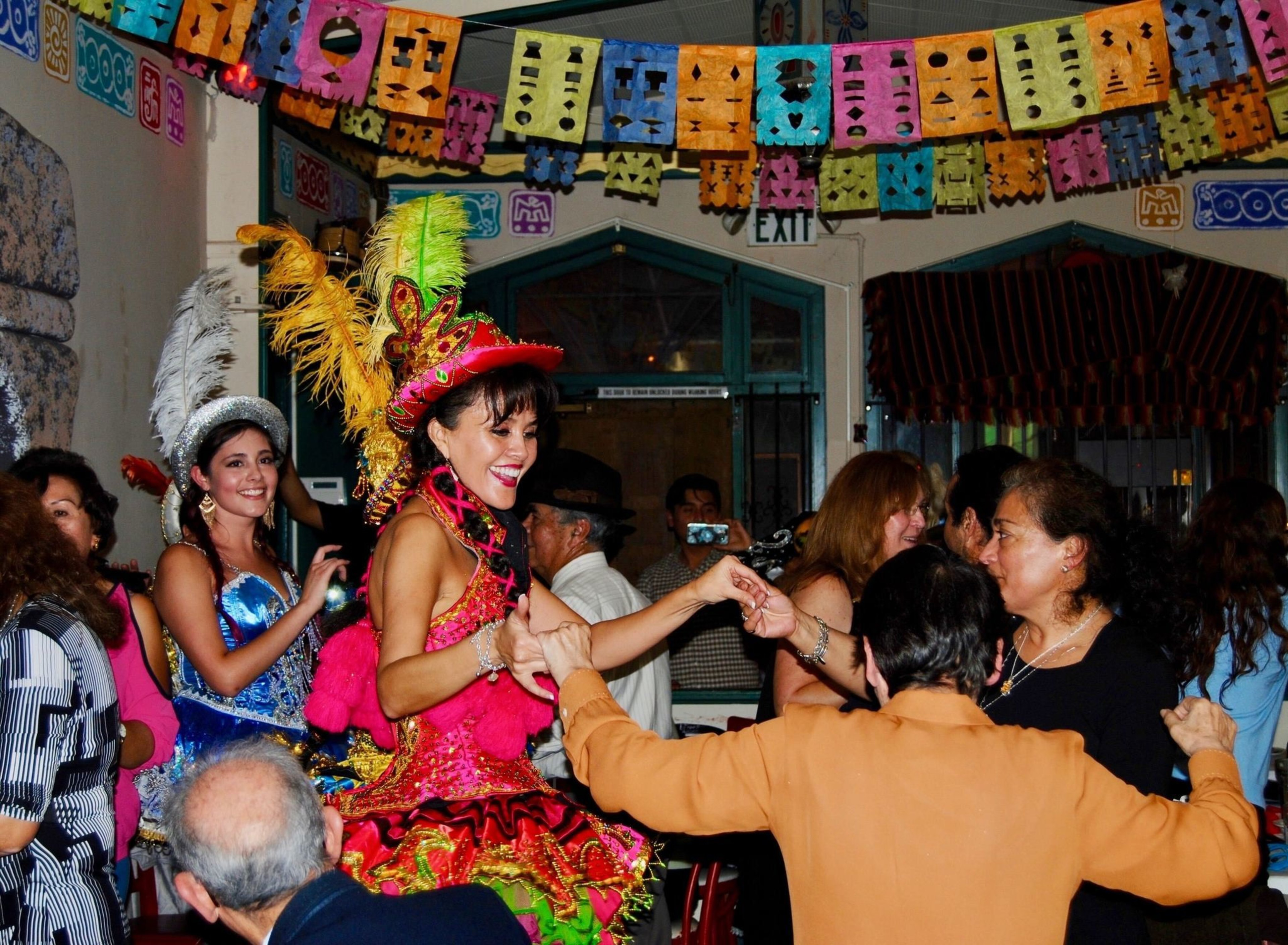 People dance inside a restaurant.