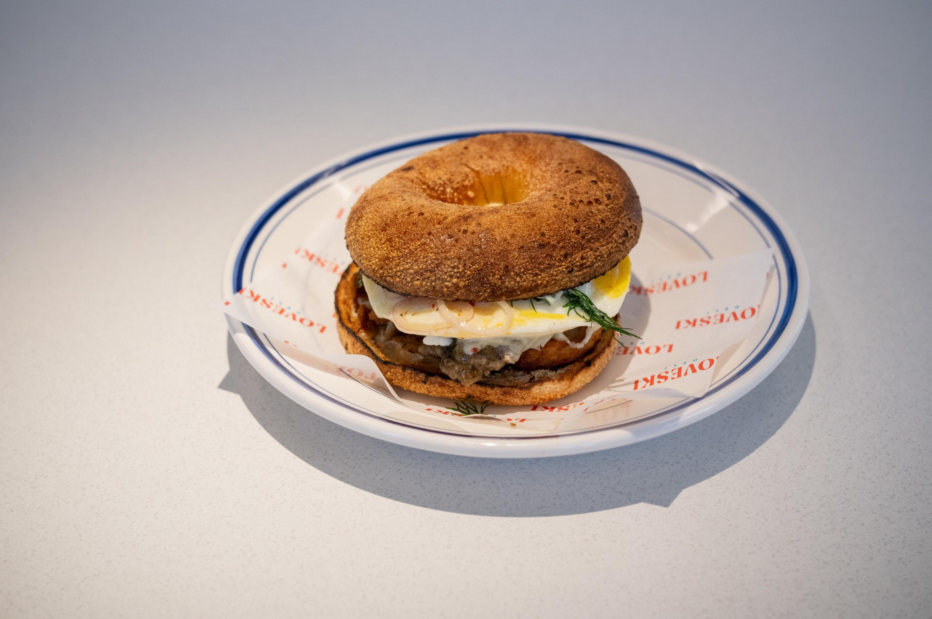 a yeast bagel &quot;all the way&quot; on a plate