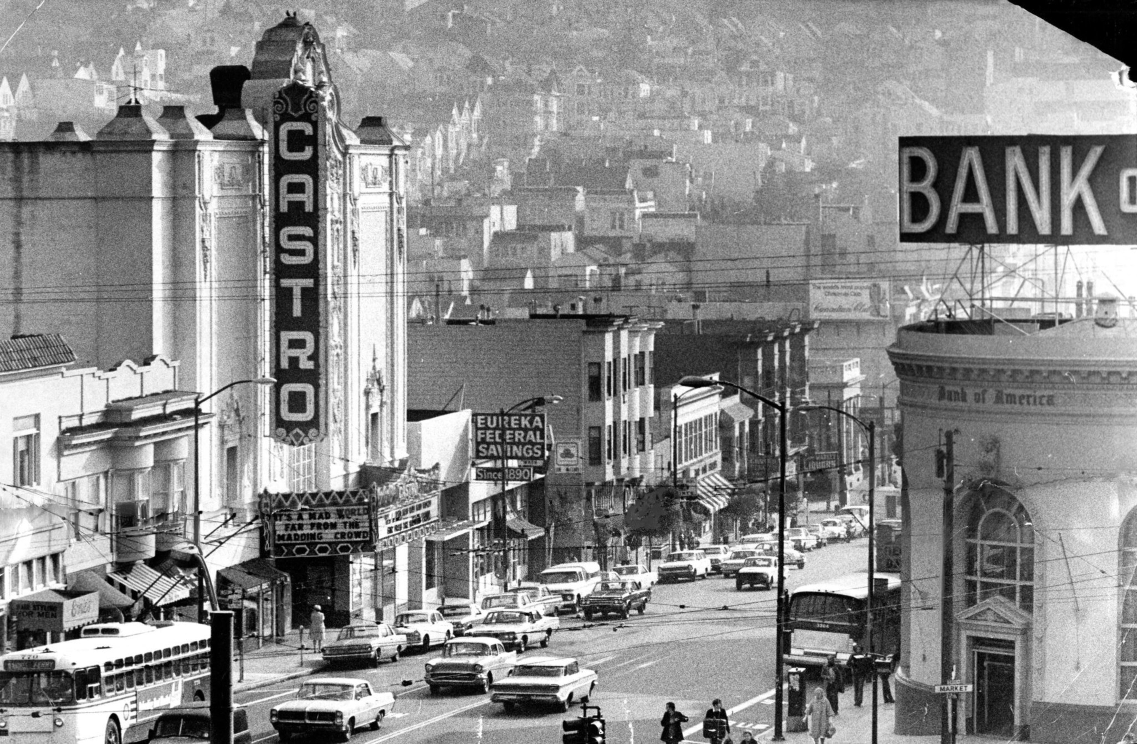 A busy street features the Castro Theatre with its vertical sign, vintage cars lined up, a Bank of America building, and various storefronts and pedestrians.