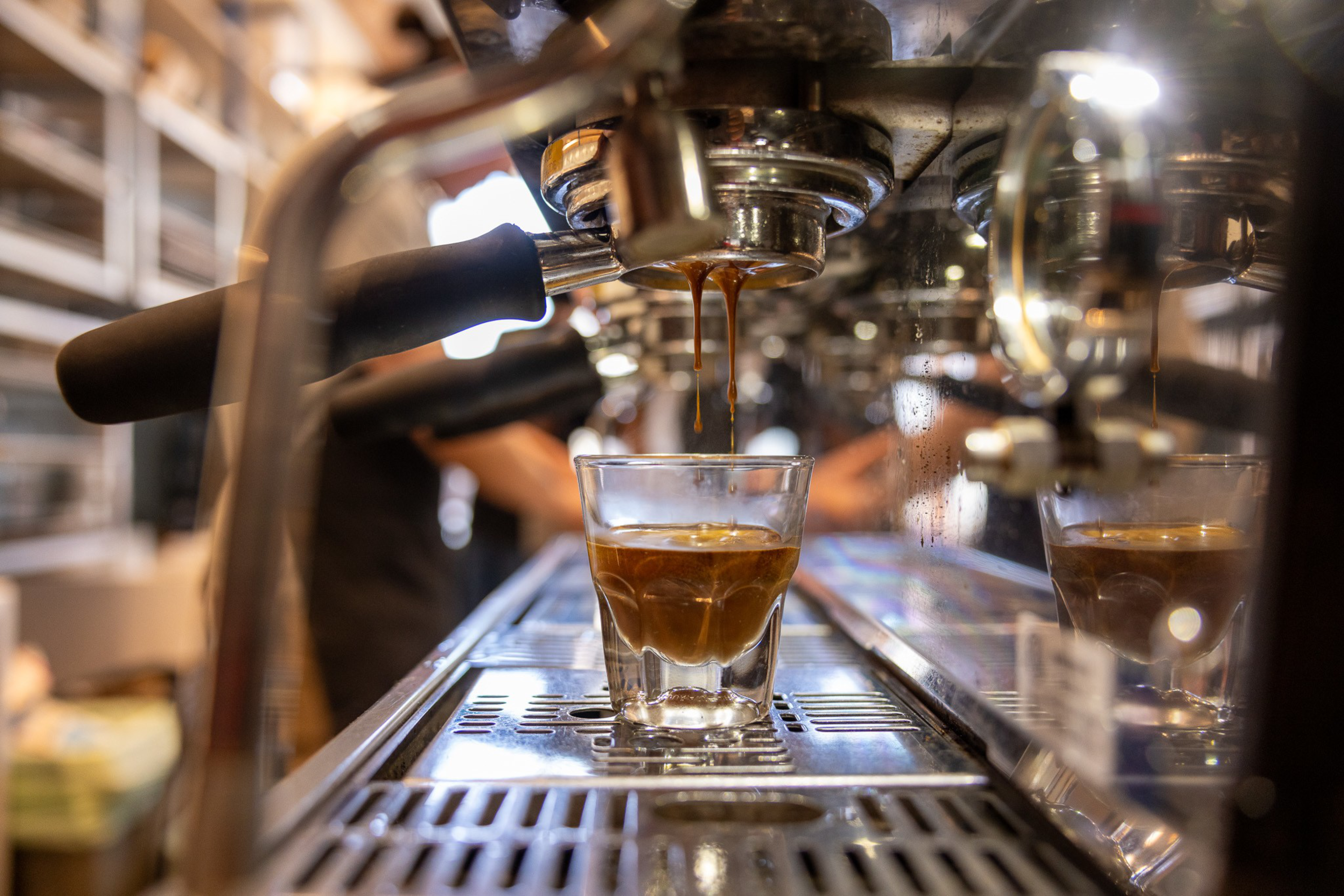 Espresso drips into a glass.