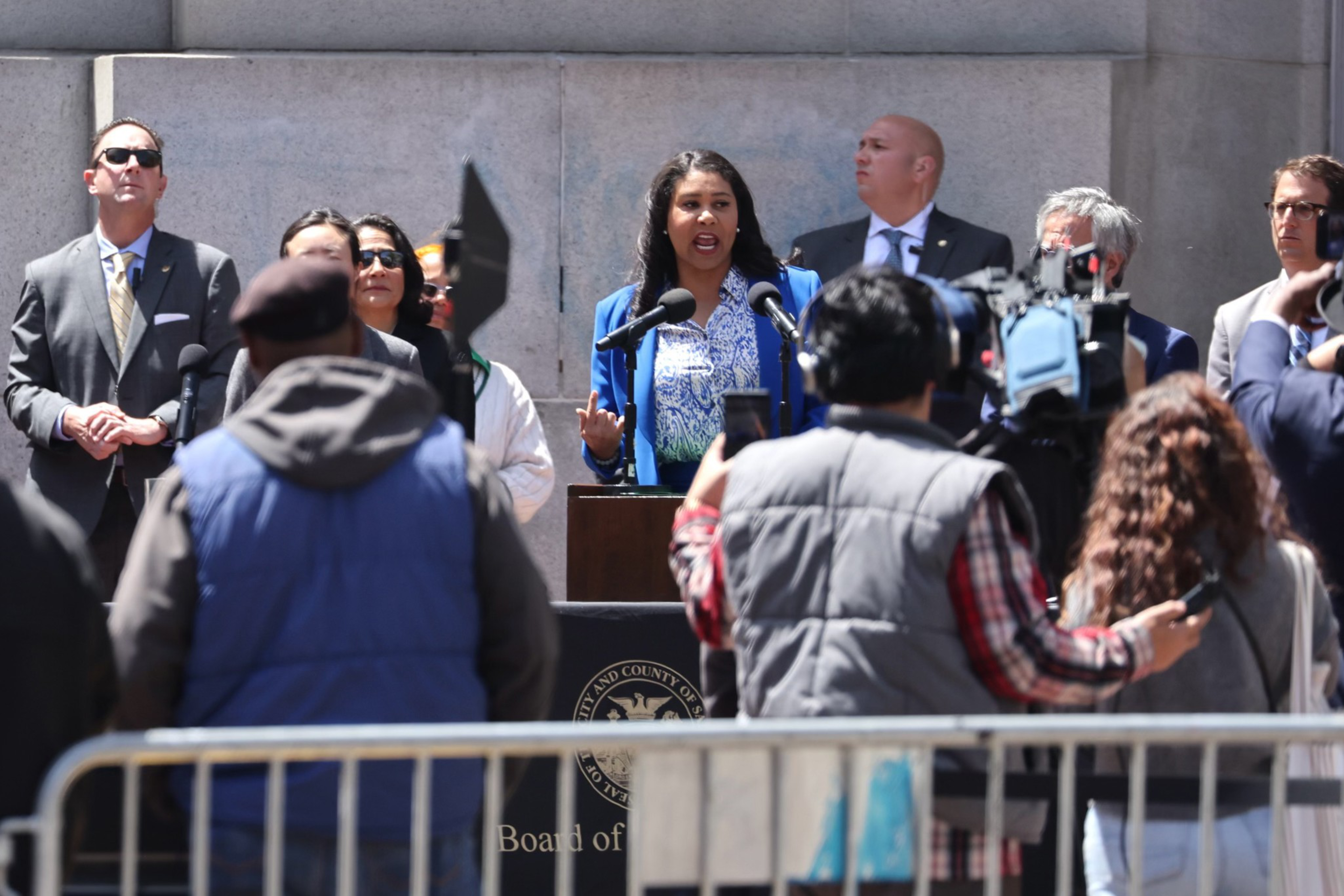 Mayor London Breed stands before a crowd at UN Plaza