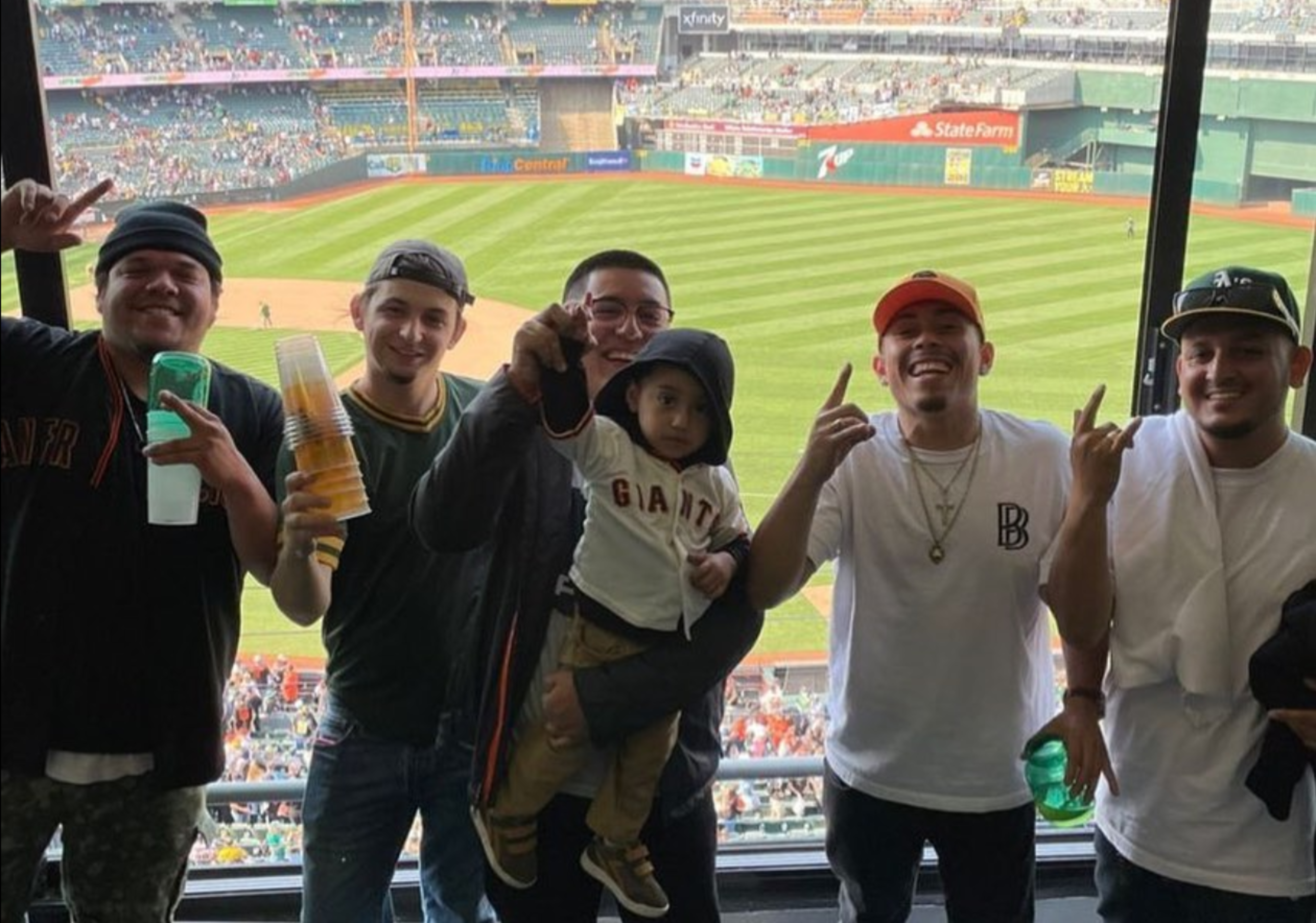Efrain Valdez, pictured second from the left, is a former Oakland A's season ticket holder blames franchise owner John Fisher for the teams woes since he acquired the team.
