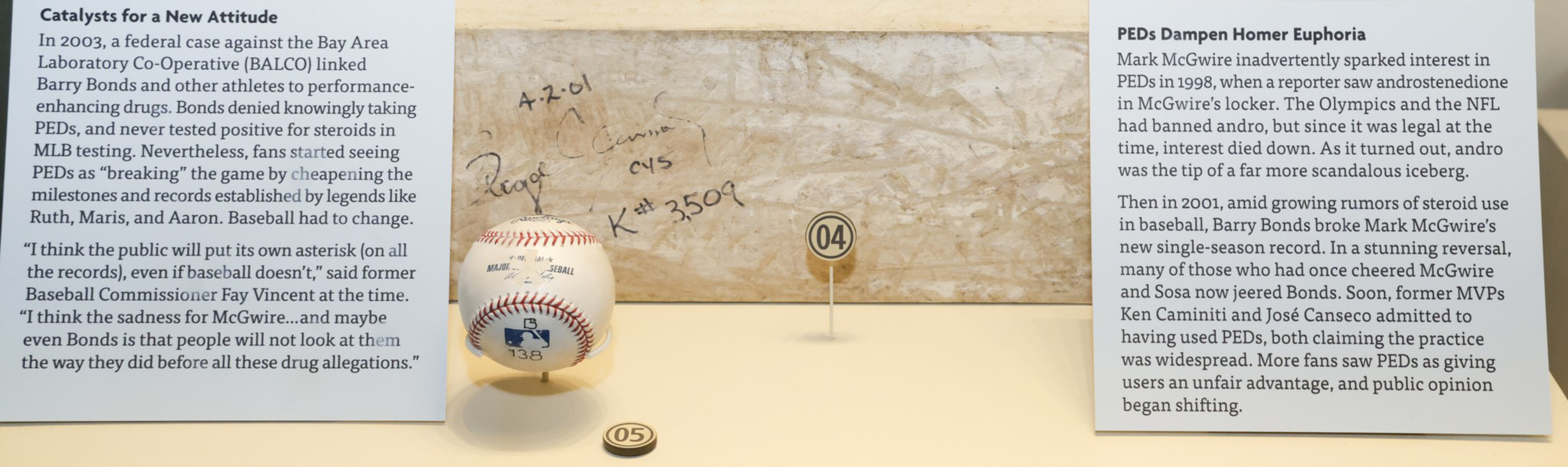 A signed baseball is displayed beside two text panels discussing PEDs in sports, specifically the Balco case and Mark McGwire's steroid use.