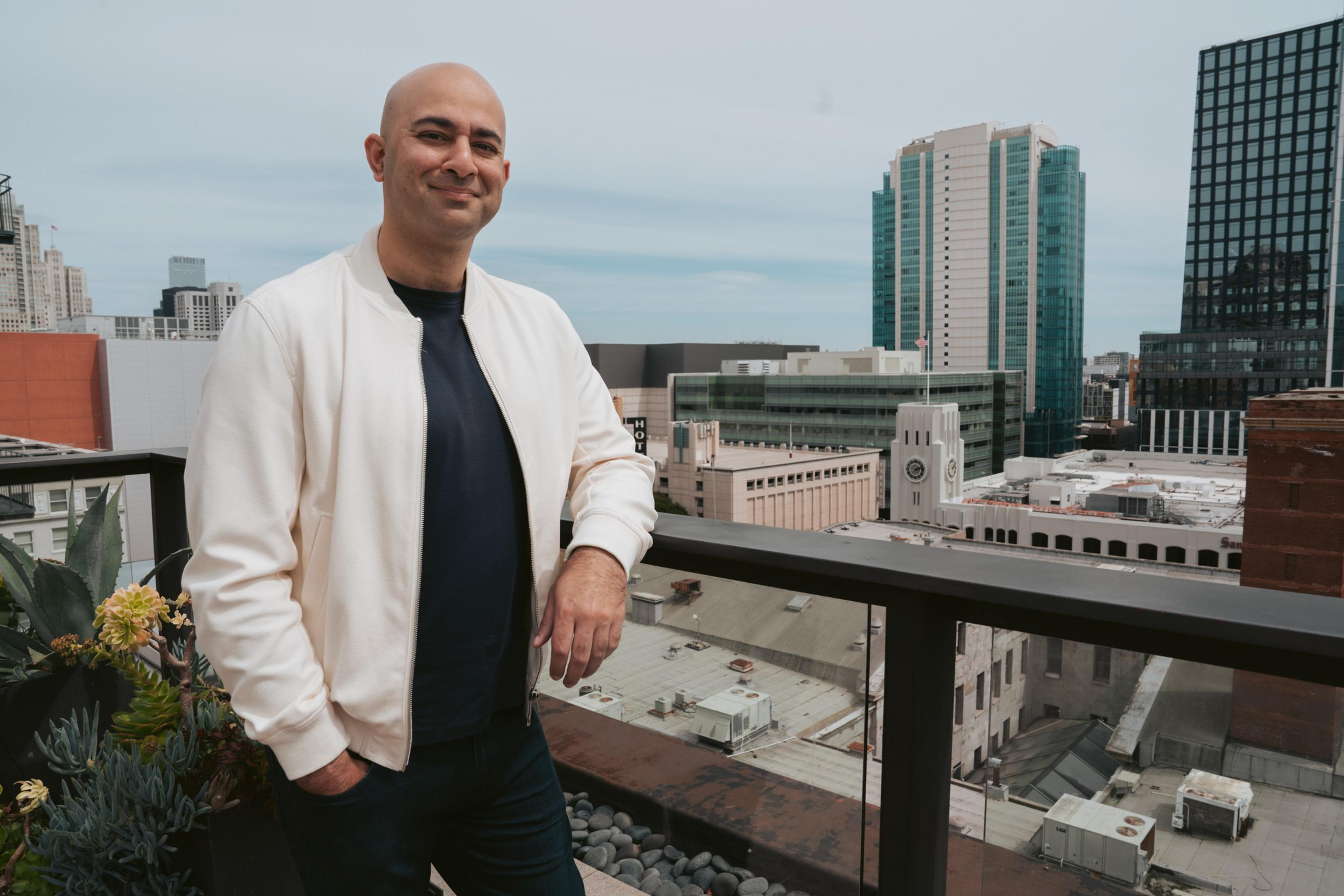Bilal Mahmood stands on a balcony.
