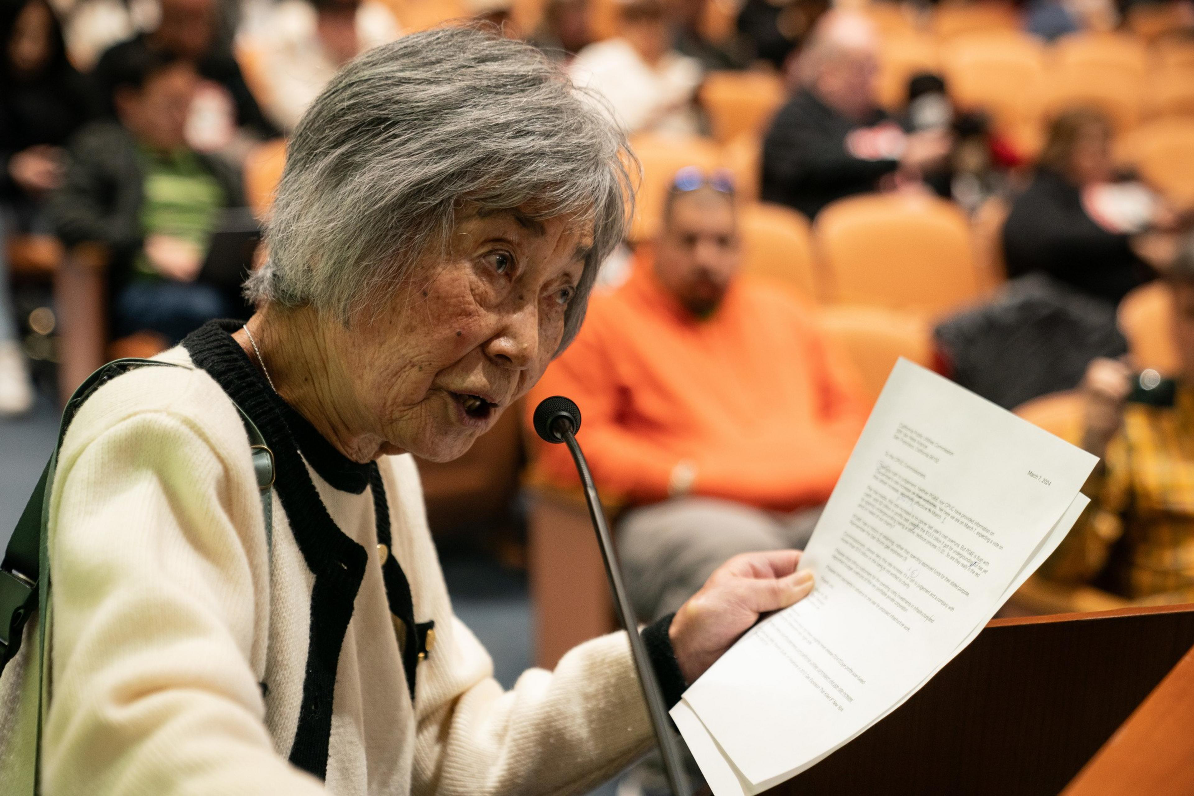 women with paper delivers statement