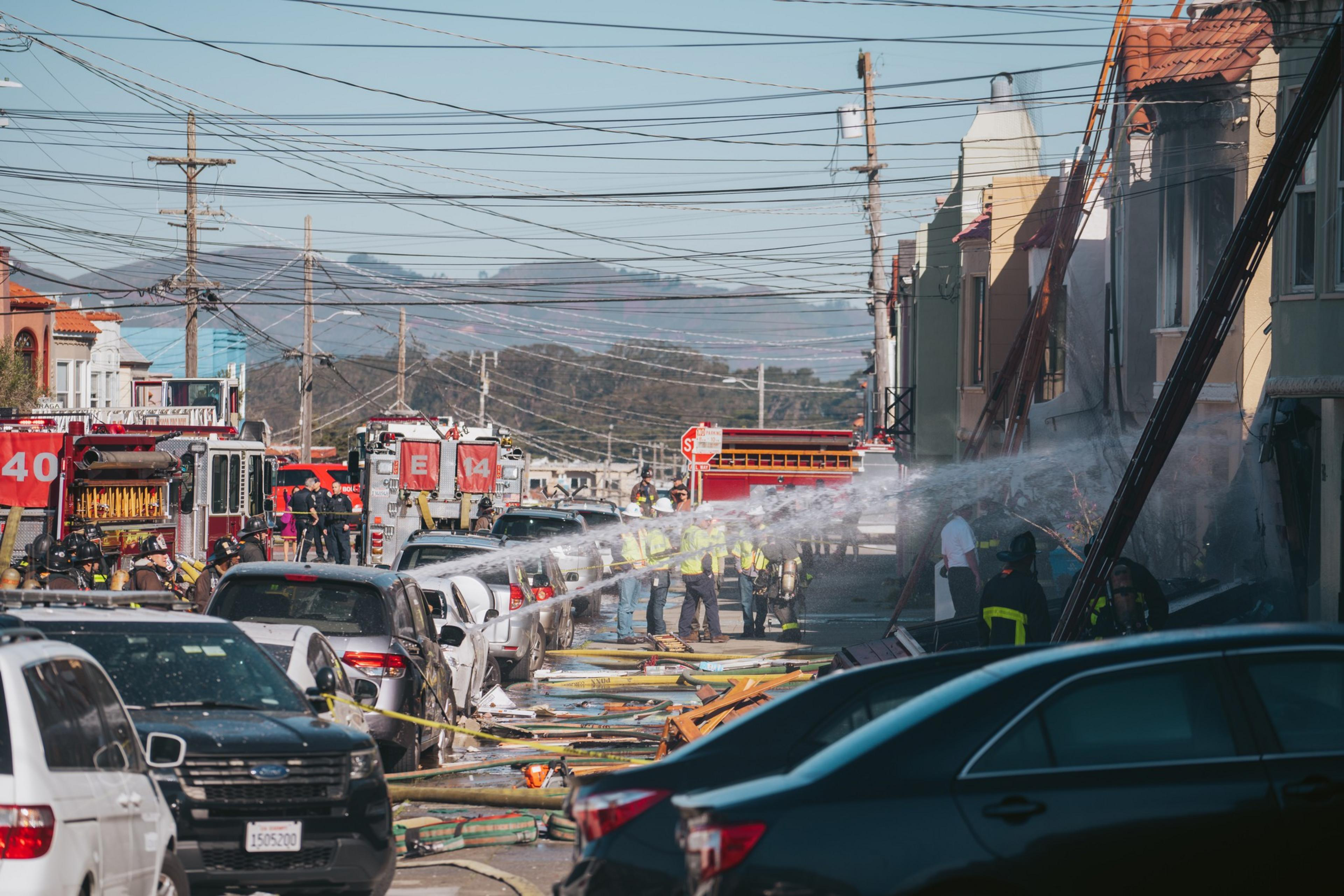 The San Francisco Fire Department spray water into the home that collapsed possibly as a result of an explosion and subsequent fire. | Michaela Vatcheva for The Standard