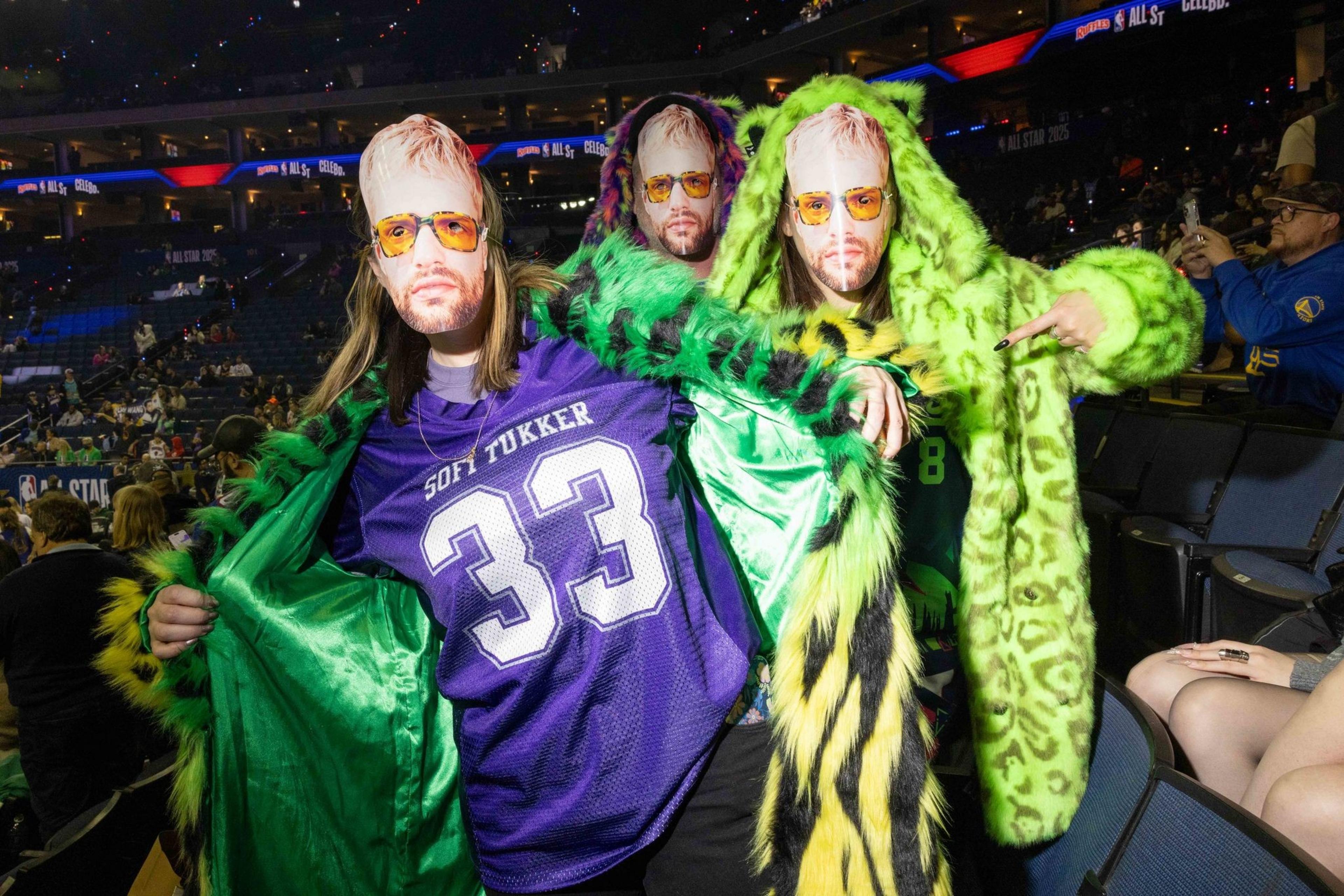 People pose wearing a mask of Tucker Halpern’s face during the celebrity All-Star Weekend game at Oakland Arena in Oakland on Friday, Feb. 14, 2025. Noah Kahan and Kai Cenat are some of the biggest names on Team Bonds, along with assistant coach 2 Chainz. Bonds also has some athletic talent with a former NBA player in Baron Davis and a two-time WNBA All-Star in Allisha Gray.