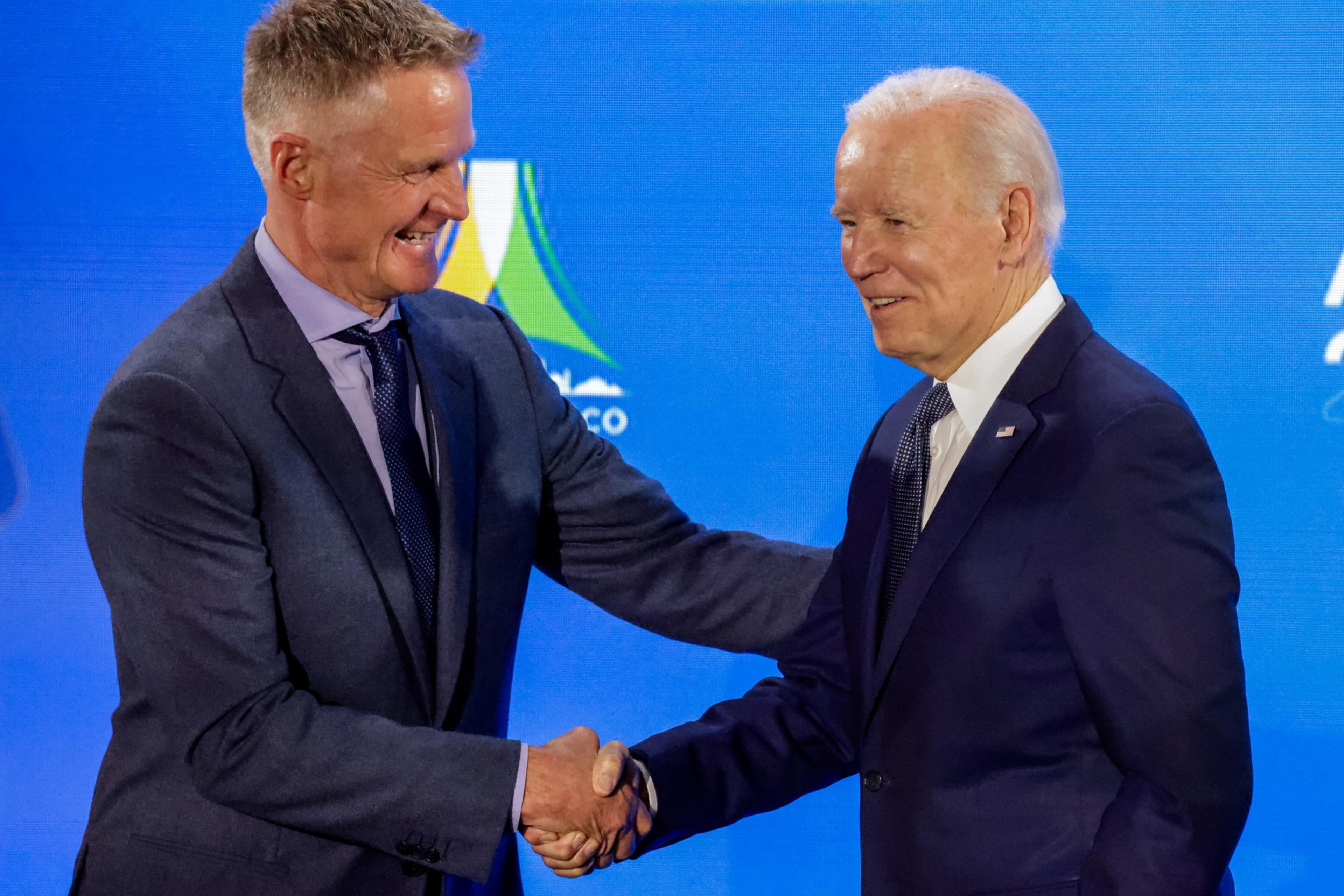 Warriors head coach Steve Kerr welcomes President Joe Biden to the stage at his welcome party during APEC week. 