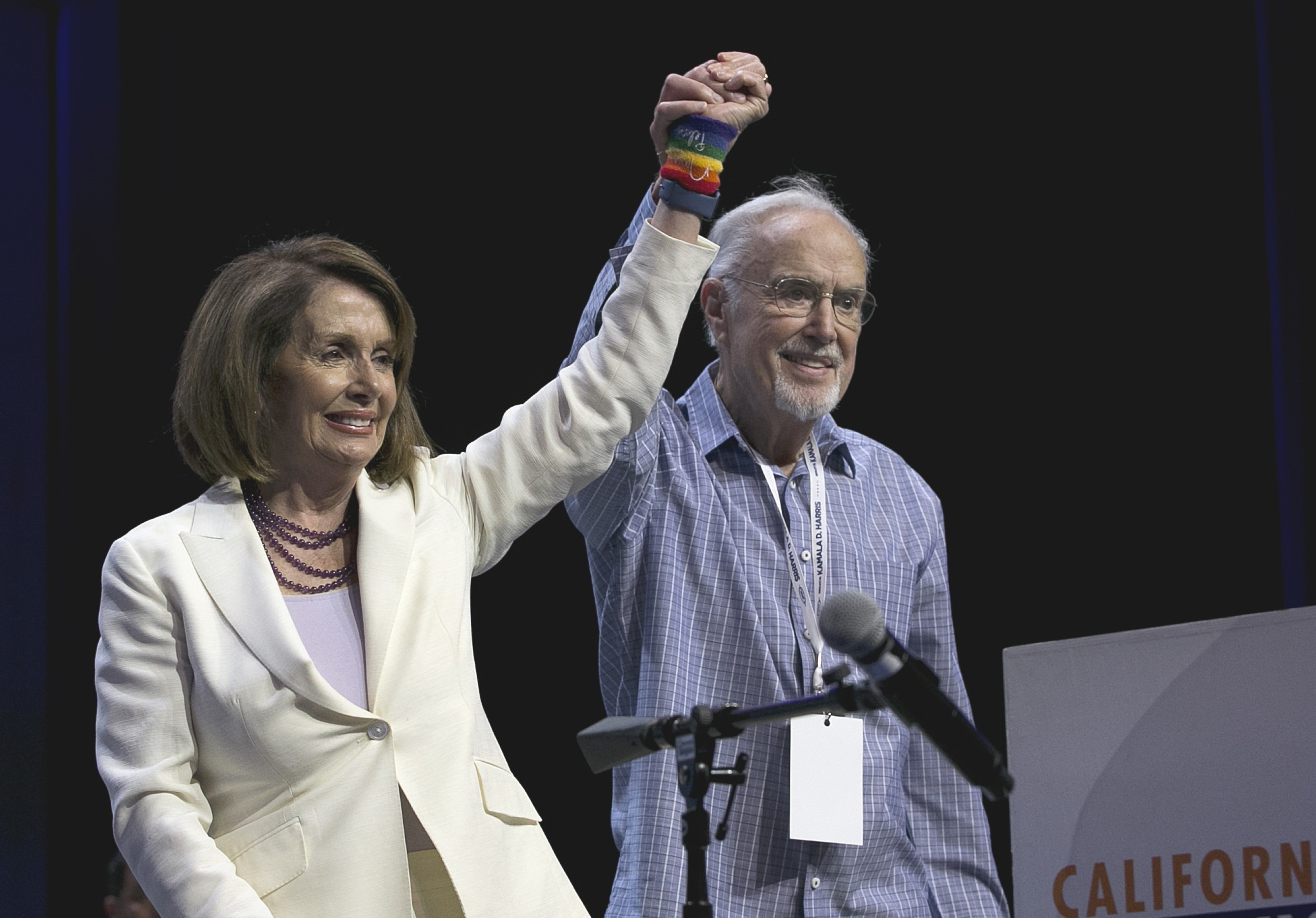 A man raises a woman's hand.