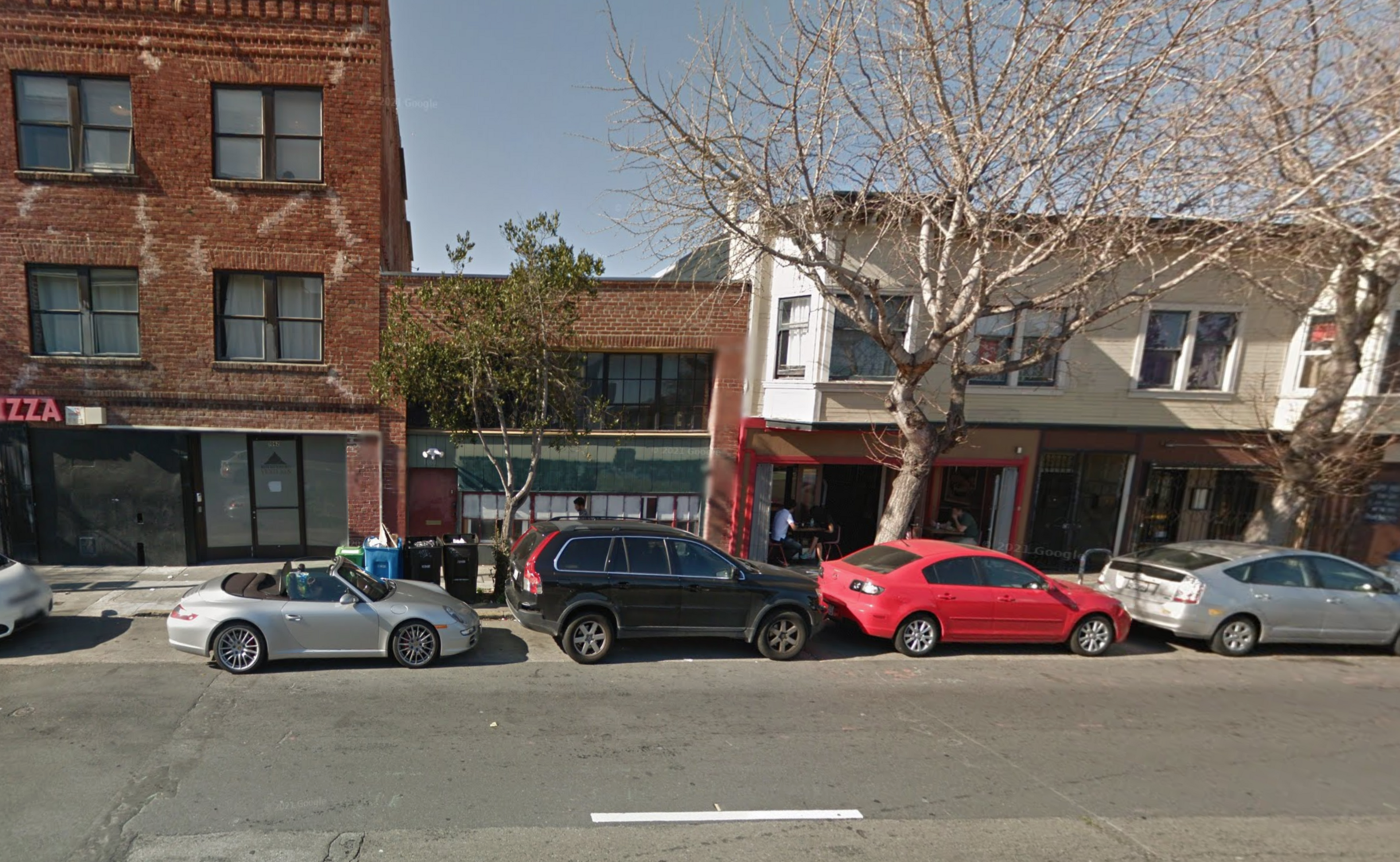 A brown building with cars parked in front of it on San Francisco's Folsom St.