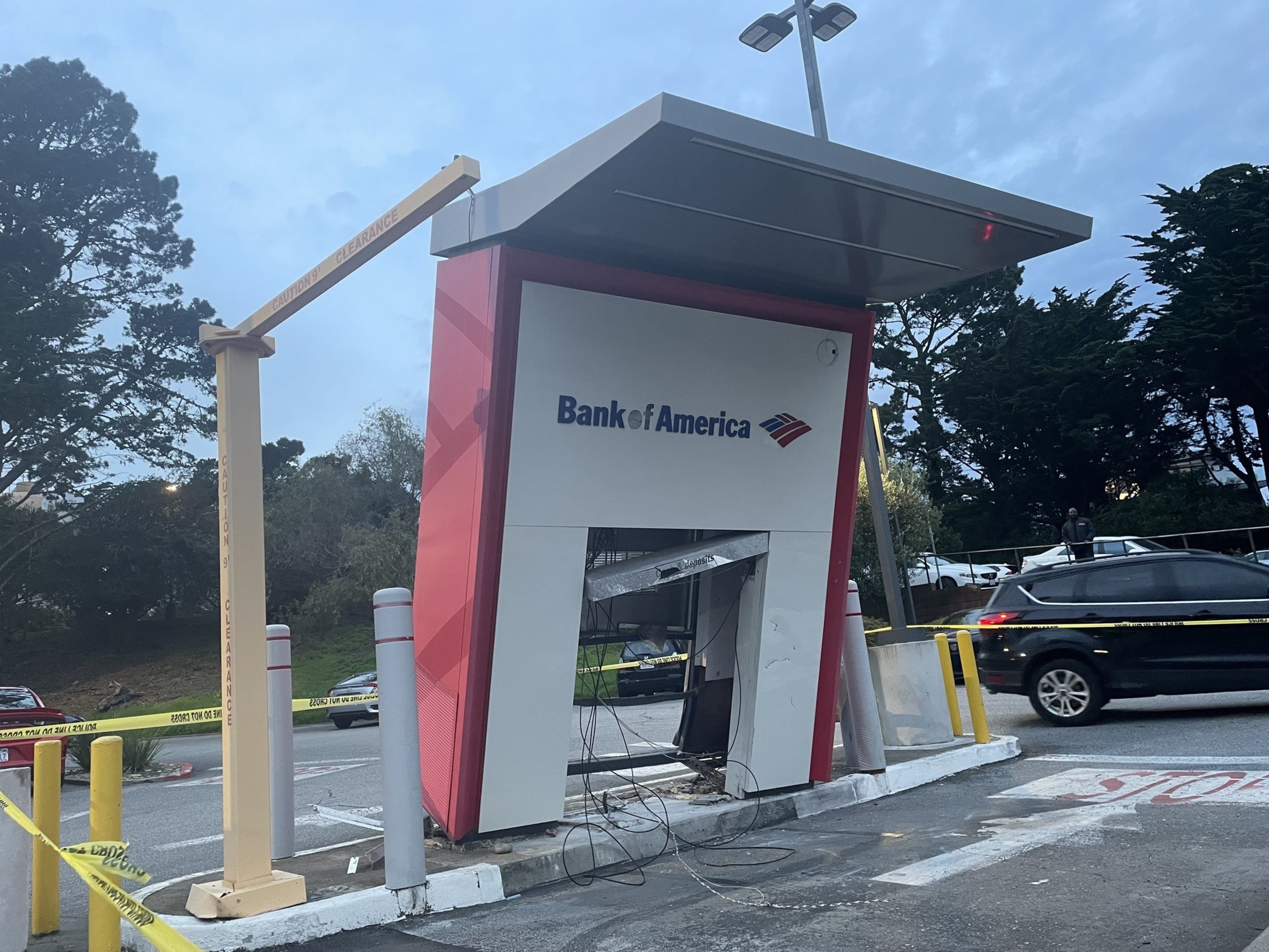 An ATM structure with &quot;Bank of America&quot; logo, surrounded by caution tape, appears damaged or under construction.