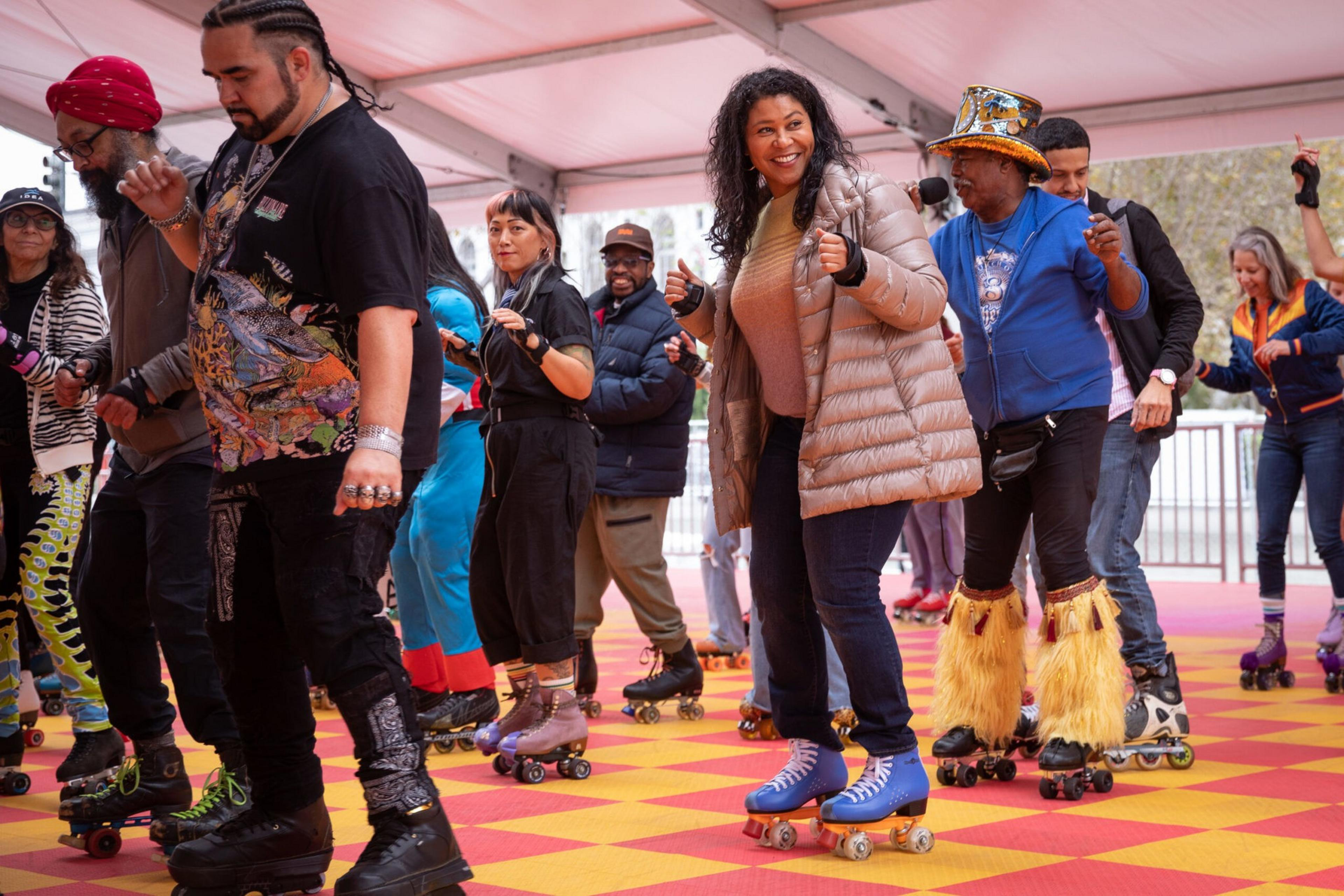 A diverse group of people roller skating indoors on a checkered floor, some smiling, wearing casual and colorful outfits with varied styles.