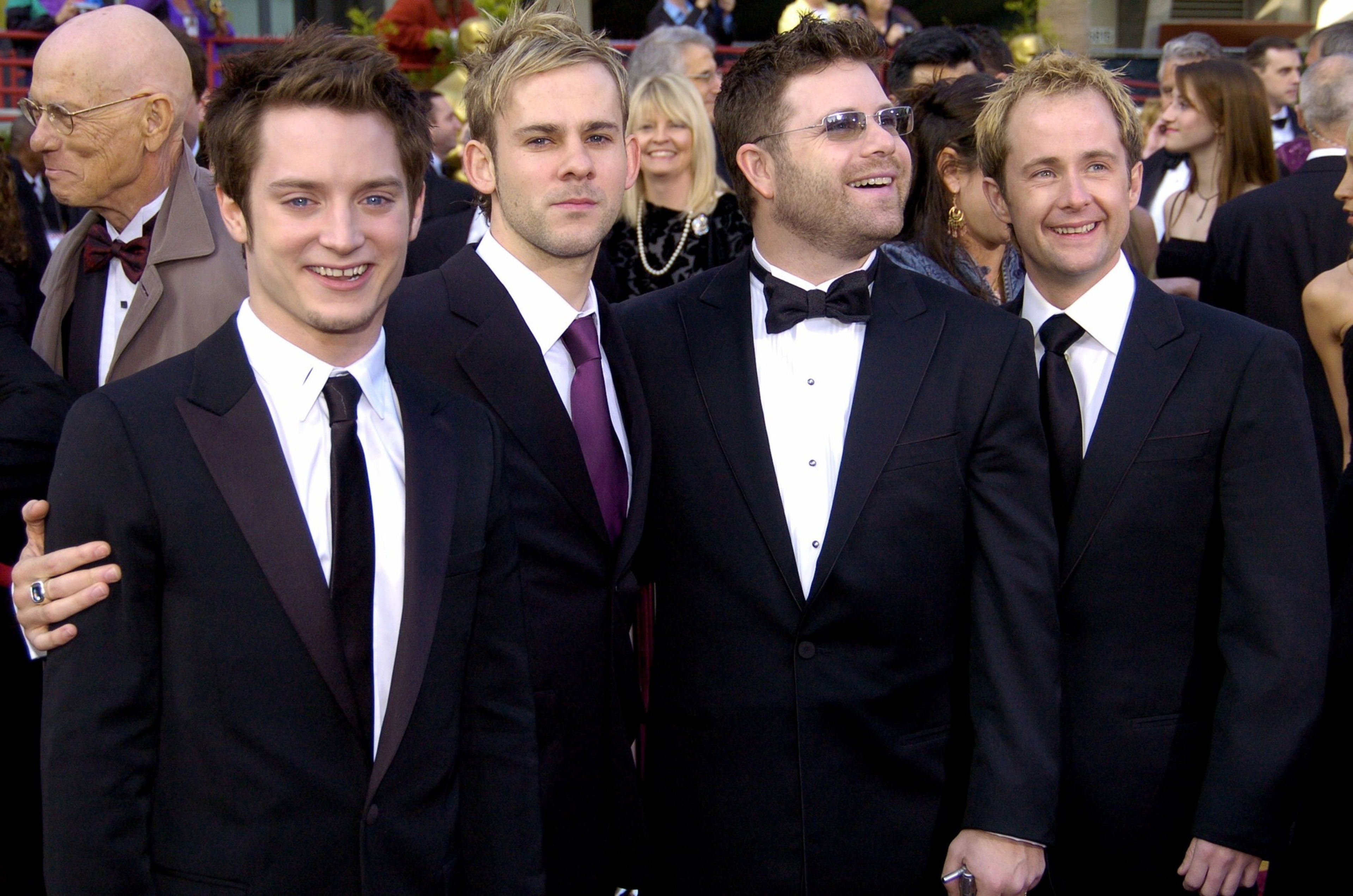 four men in suits stand shoulder-to-shoulder at an award ceremony