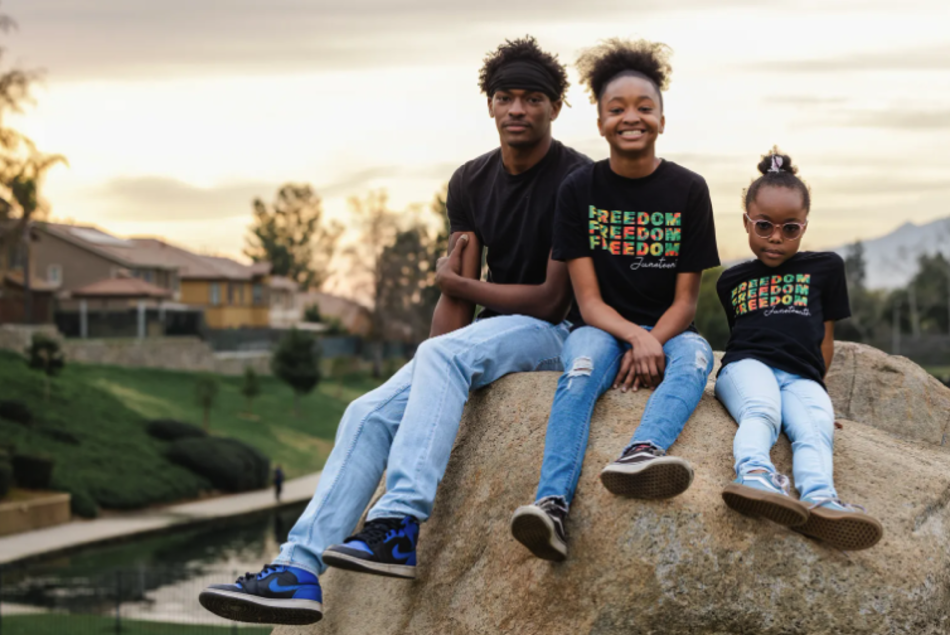 Kids sit outside their home