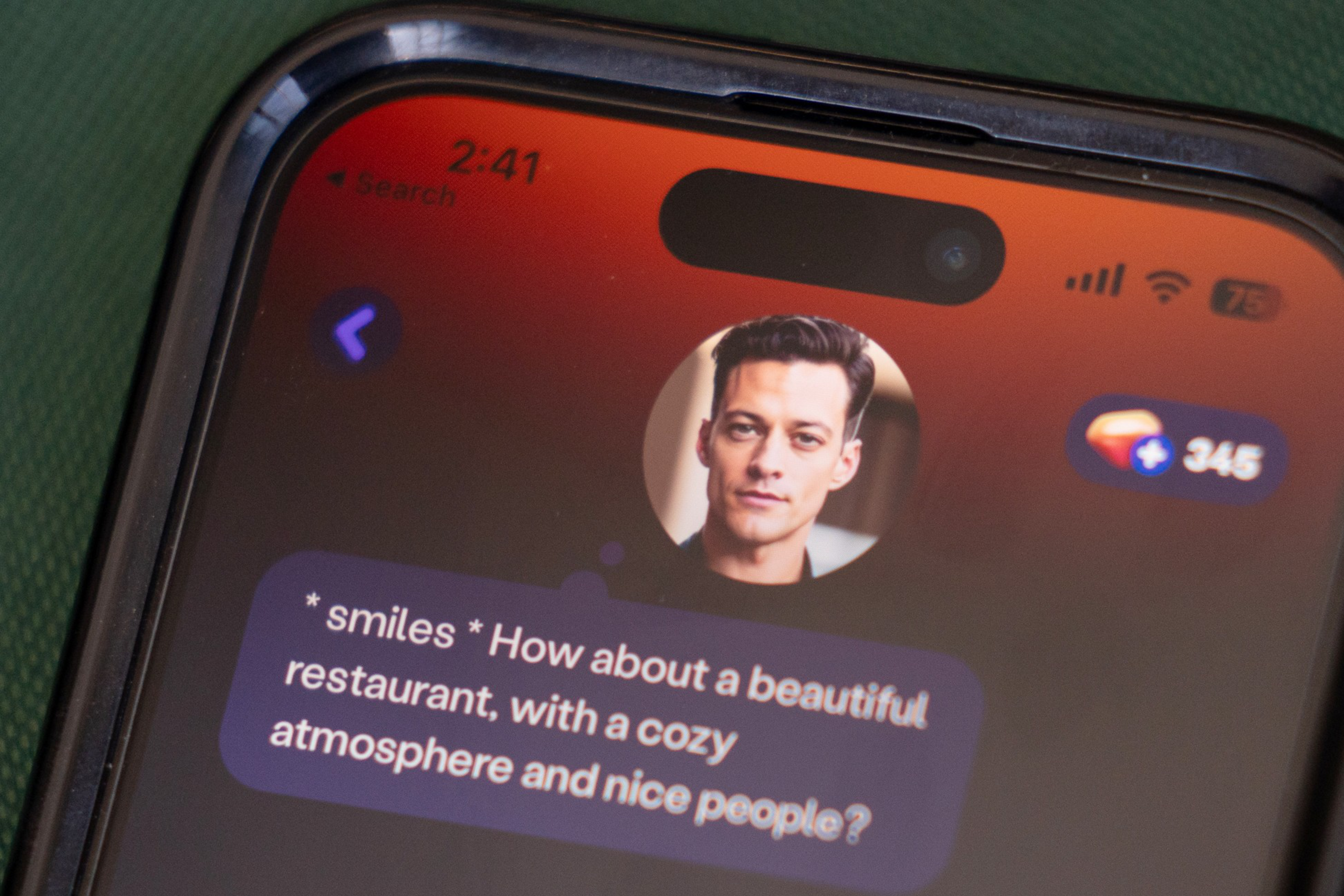A phone screen shows a chat message from a man suggesting, "*smiles* How about a beautiful restaurant, with a cozy atmosphere and nice people?"