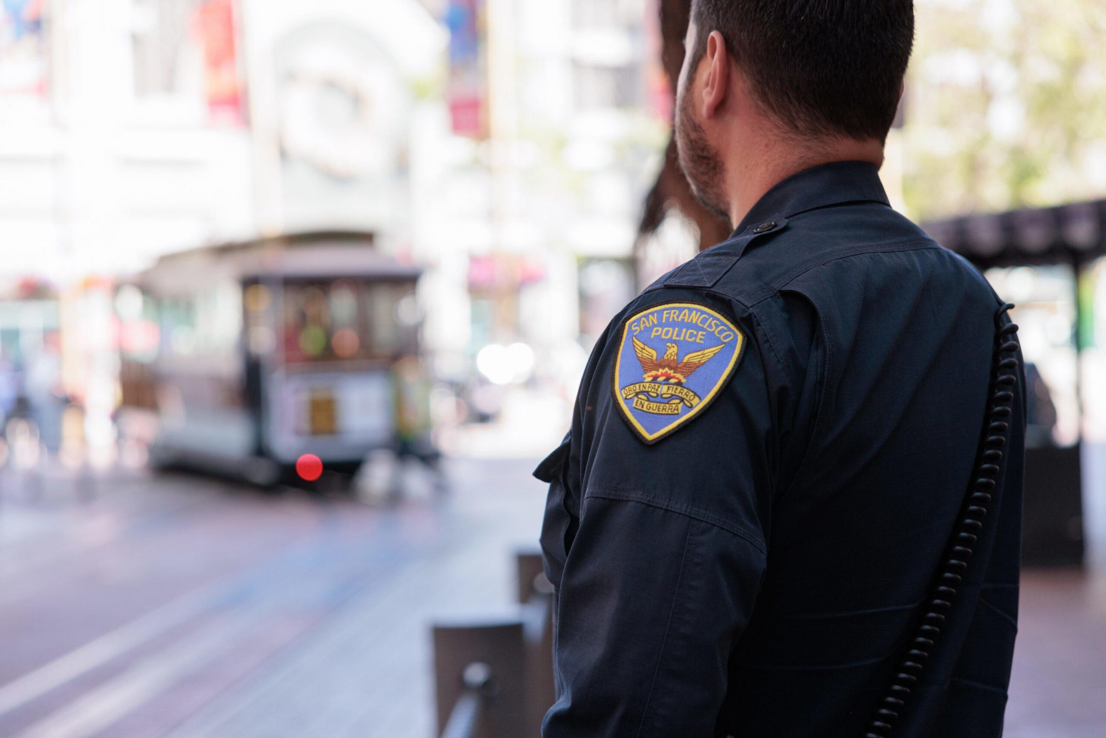 A San Francisco Police Department officer stands near the cable-car turntable at Powell and Market streets in San Francisco on June 20, 2023.