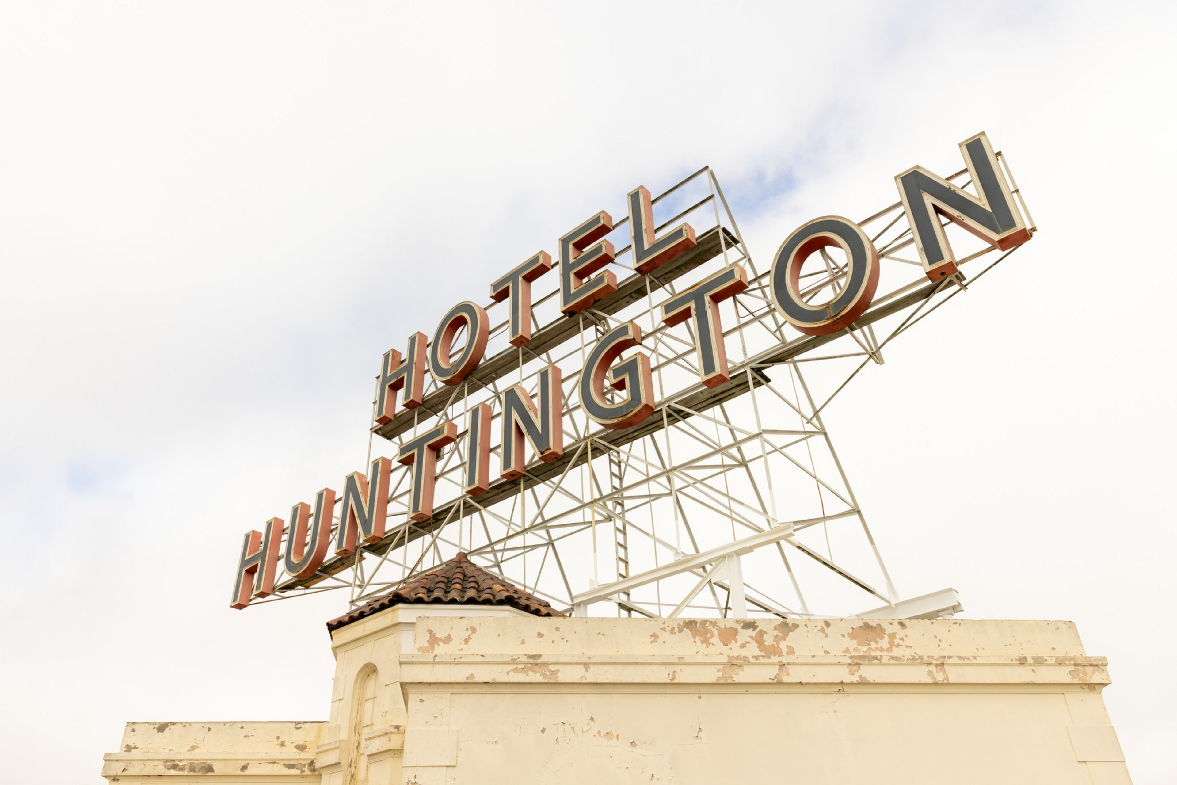 A large vintage rooftop sign reading “HOTEL HUNTINGTON” stands on an ...