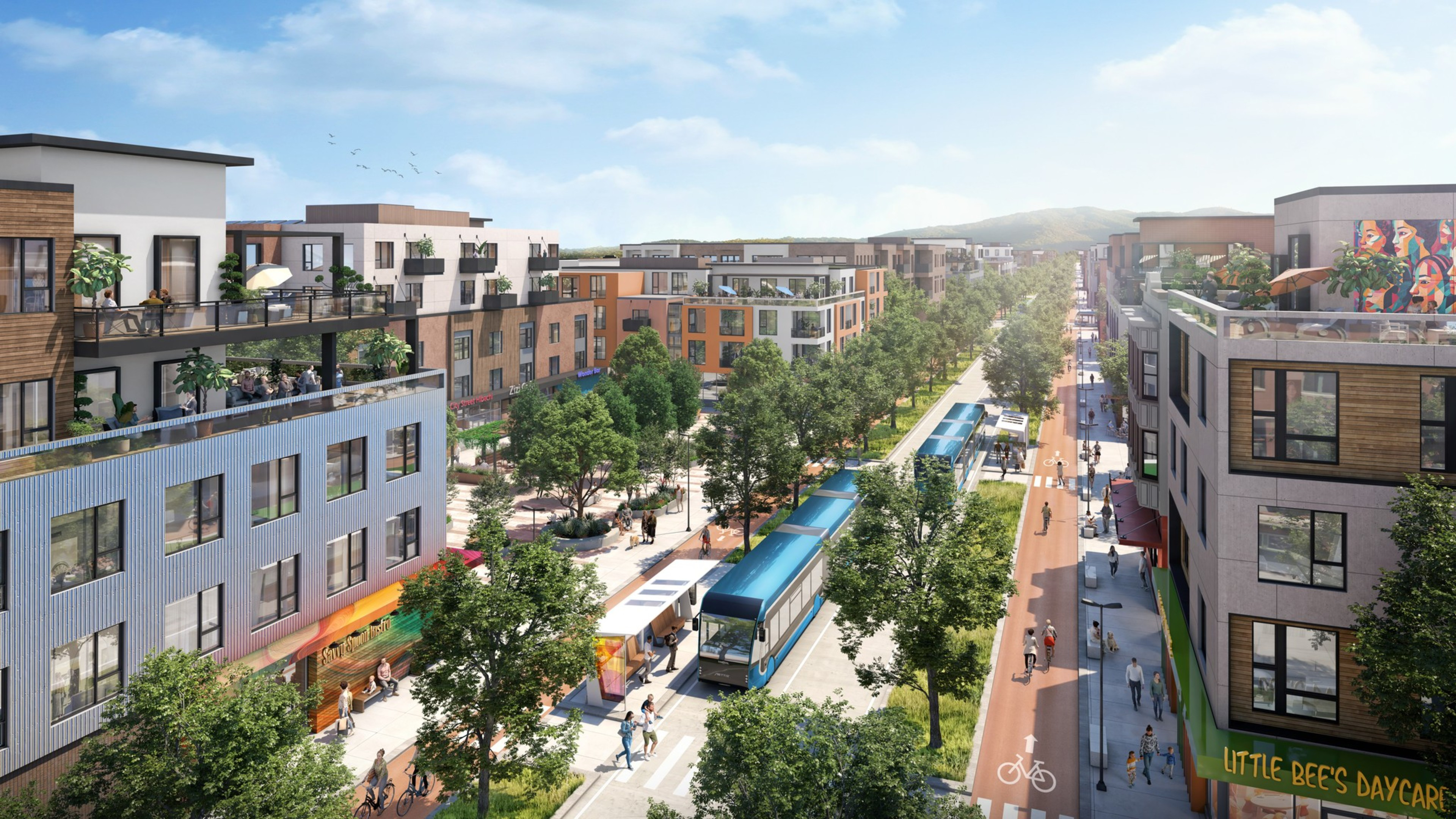 The image shows a modern urban street lined with trees and low-rise buildings. There's a blue tram in the center and people walking and cycling along the sidewalks.
