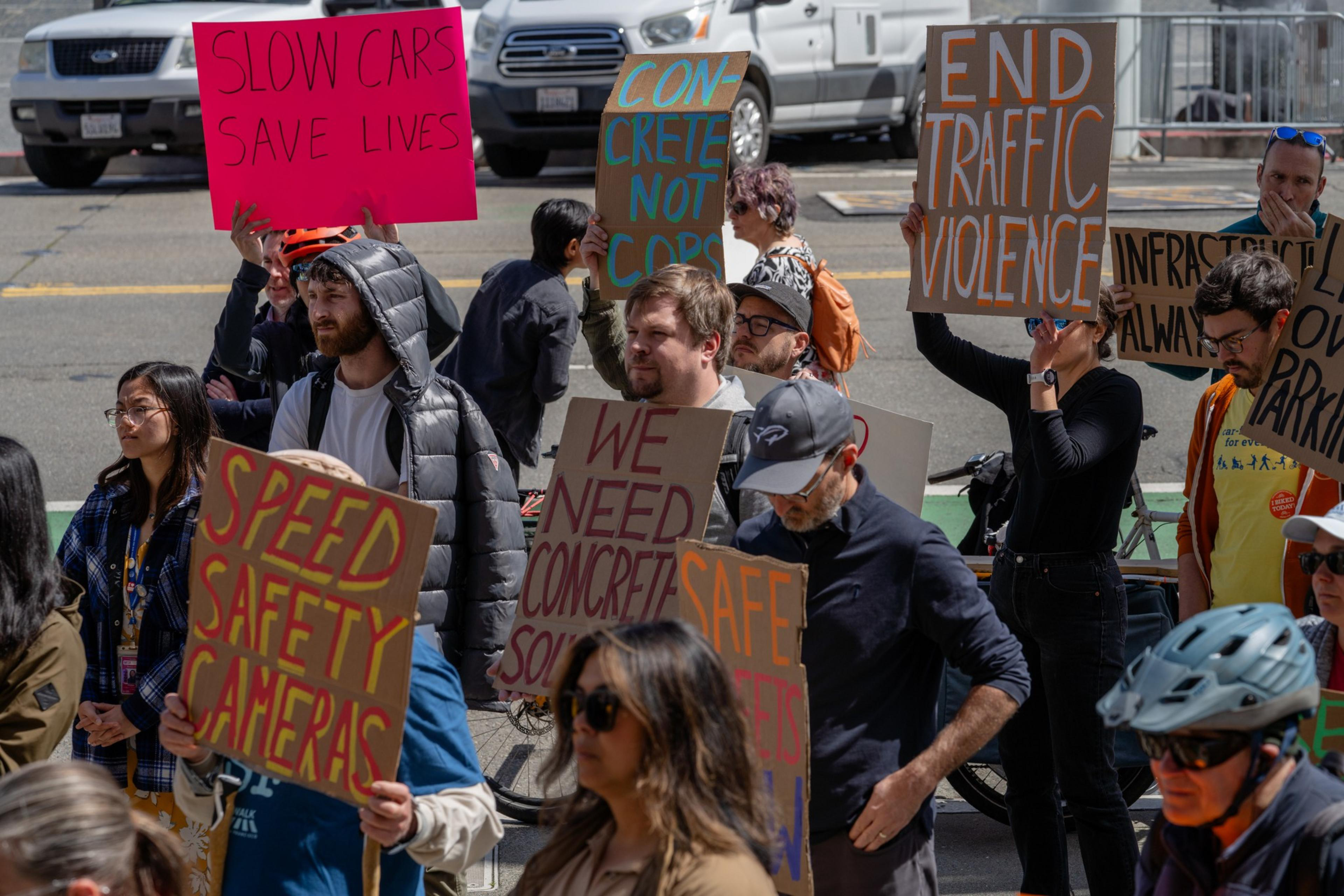 Large group of people holding signs advocating street safety