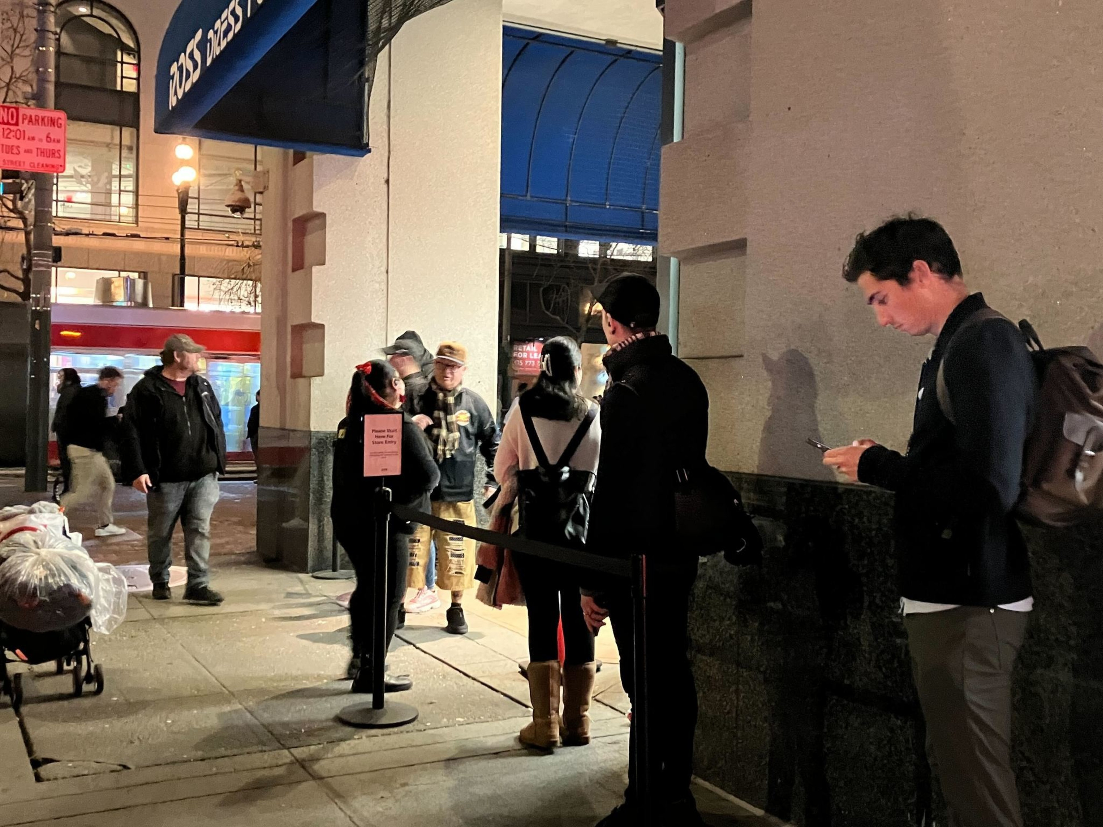 People line up to enter during evening hours outside the Downtown San Francisco Ross Dress for Less store.