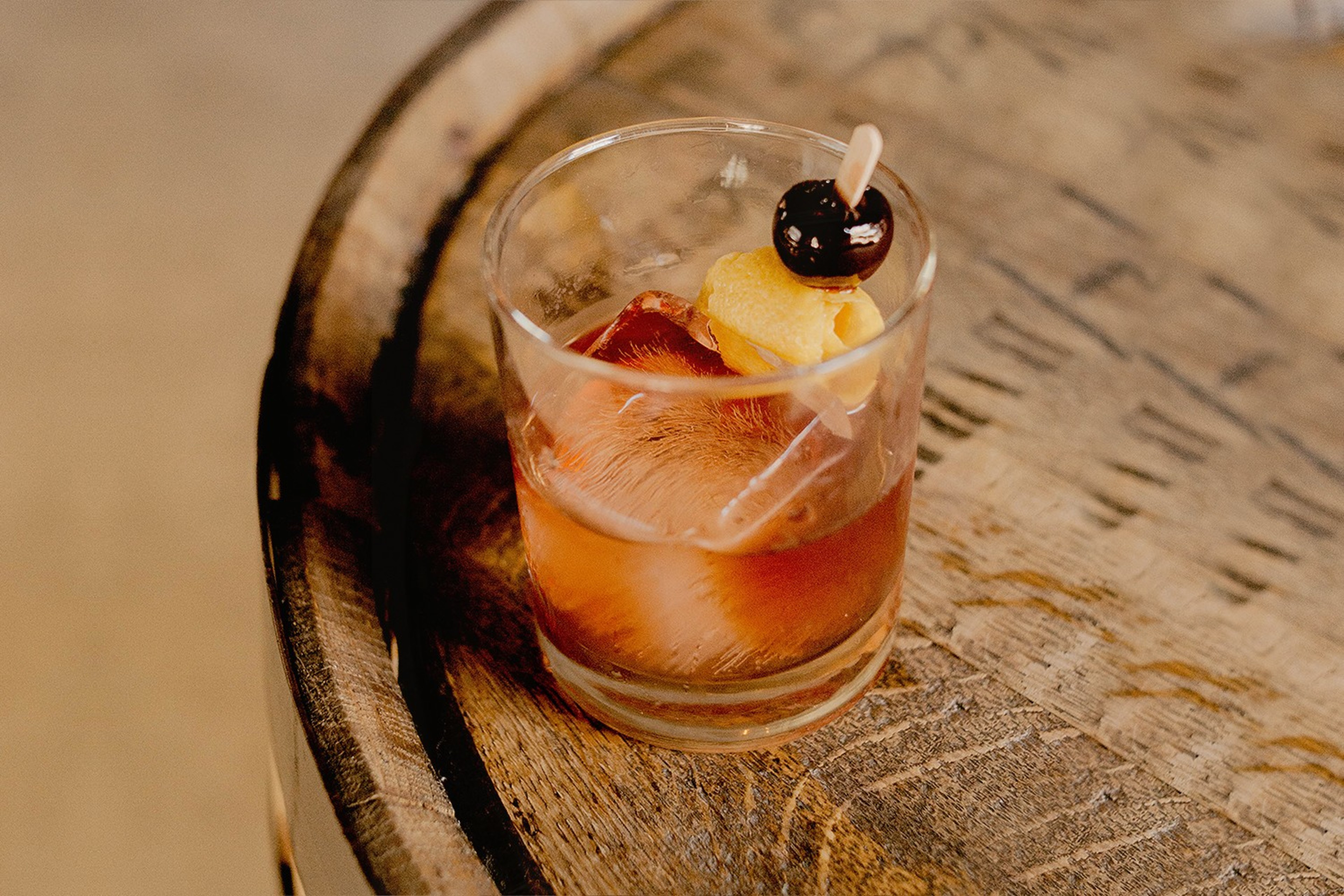 A photo shows an old-fashioned cocktail.