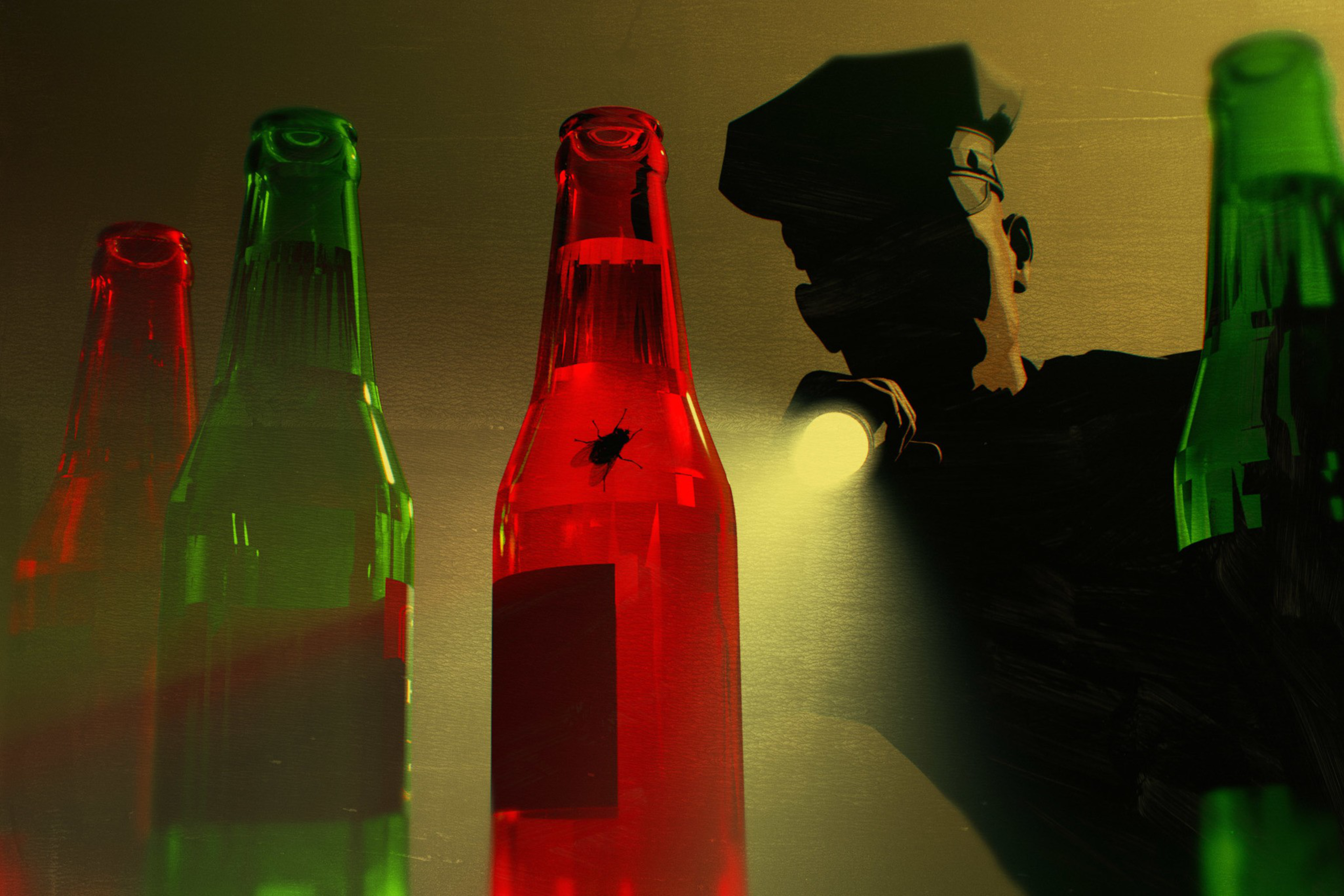 A person shines a flashlight on a red bottle with a bug inside, surrounded by other green and red bottles.