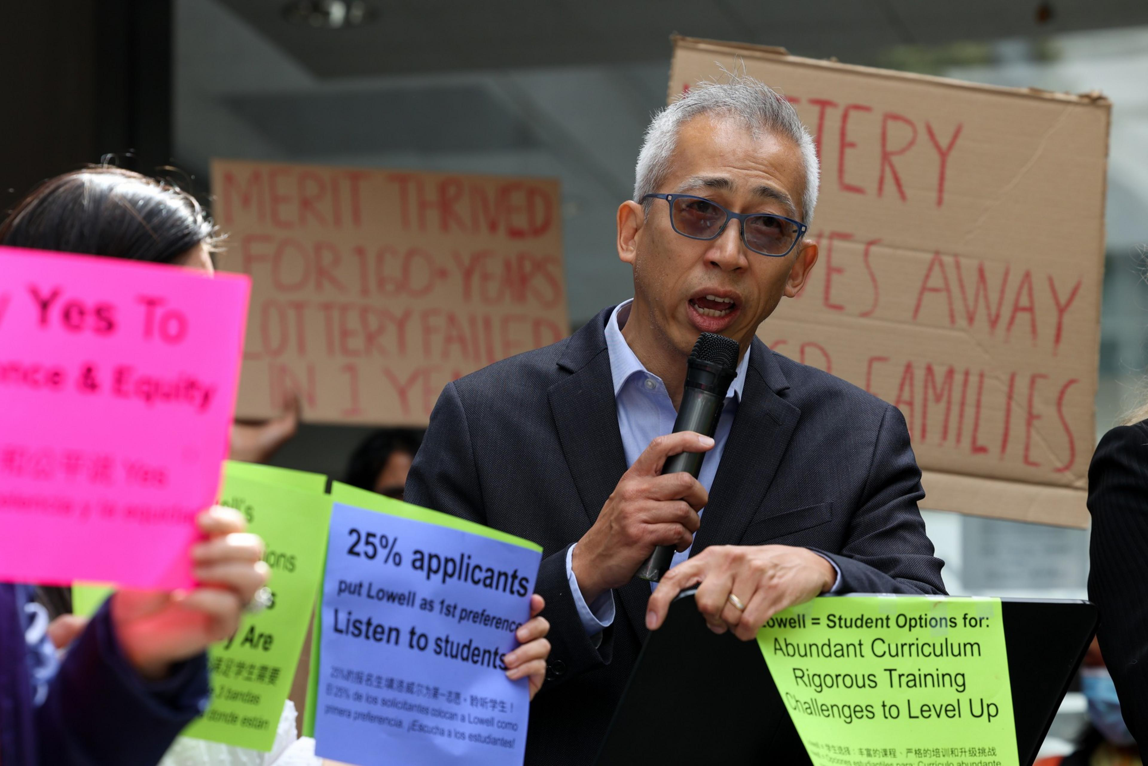 A man speaks into a microphone during a protest