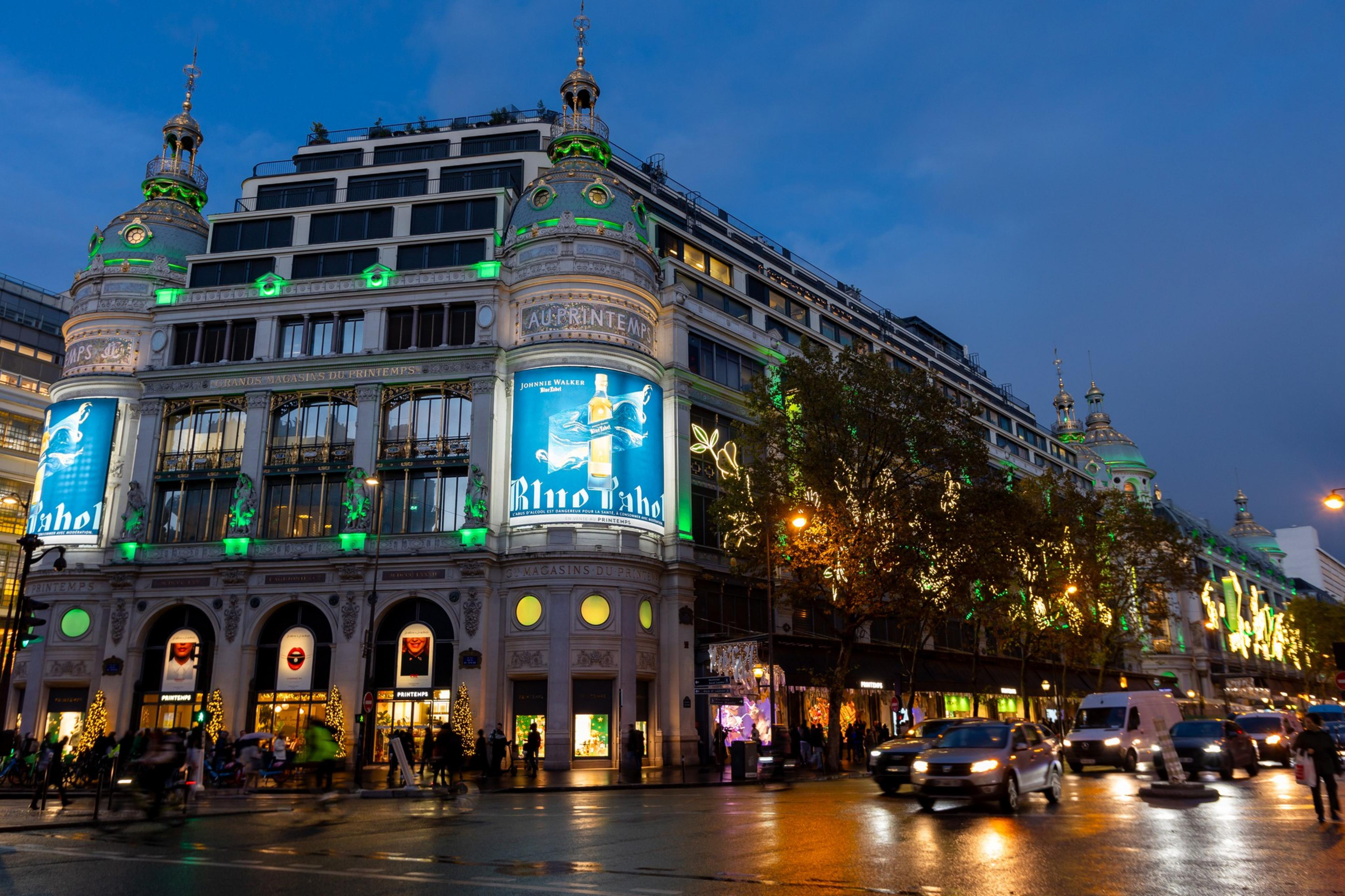 Massive department stores with flowing windows and traffic around