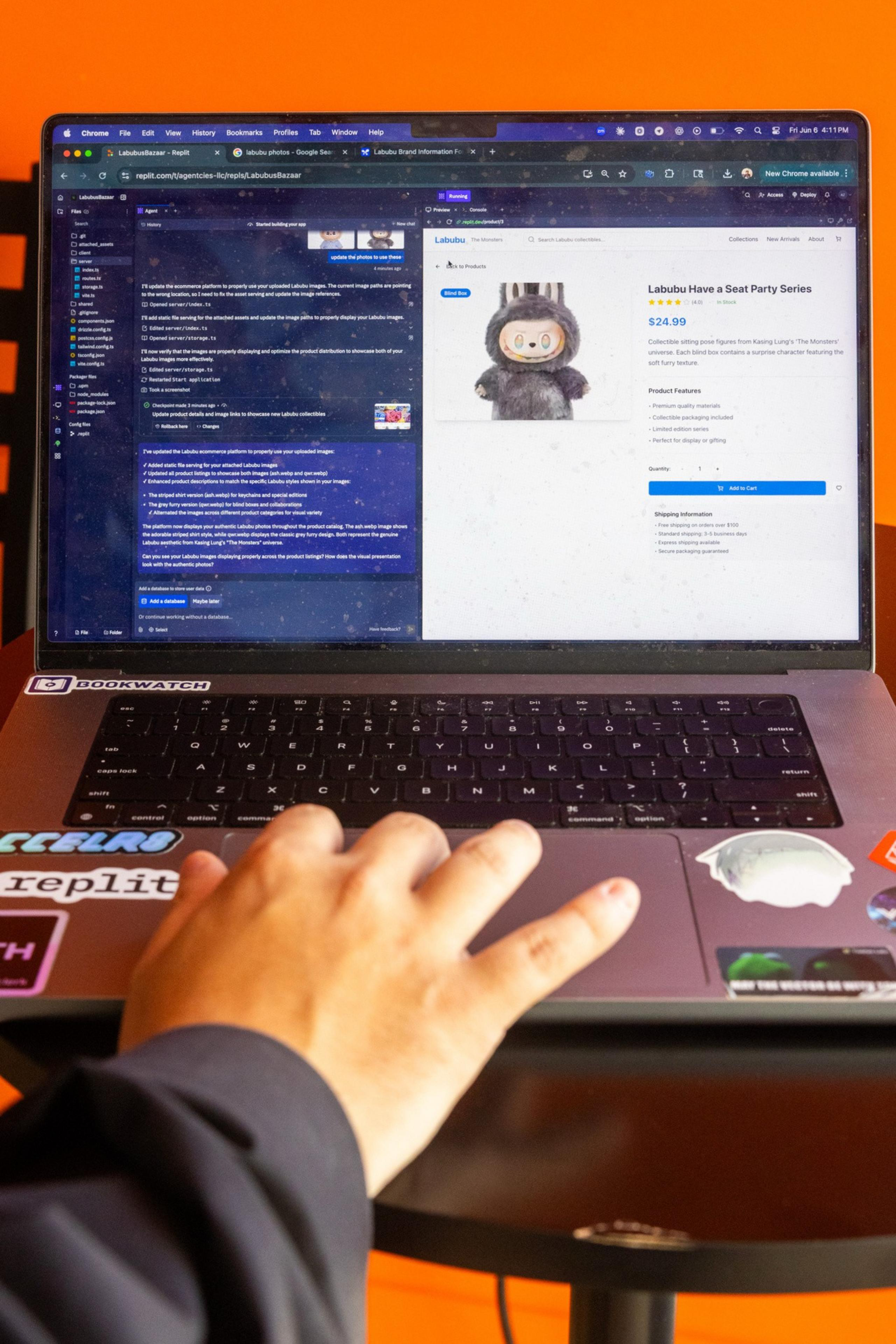 A person uses a laptop displaying a webpage with a toy figure for sale. The laptop's lid has several stickers, and there's an orange background.