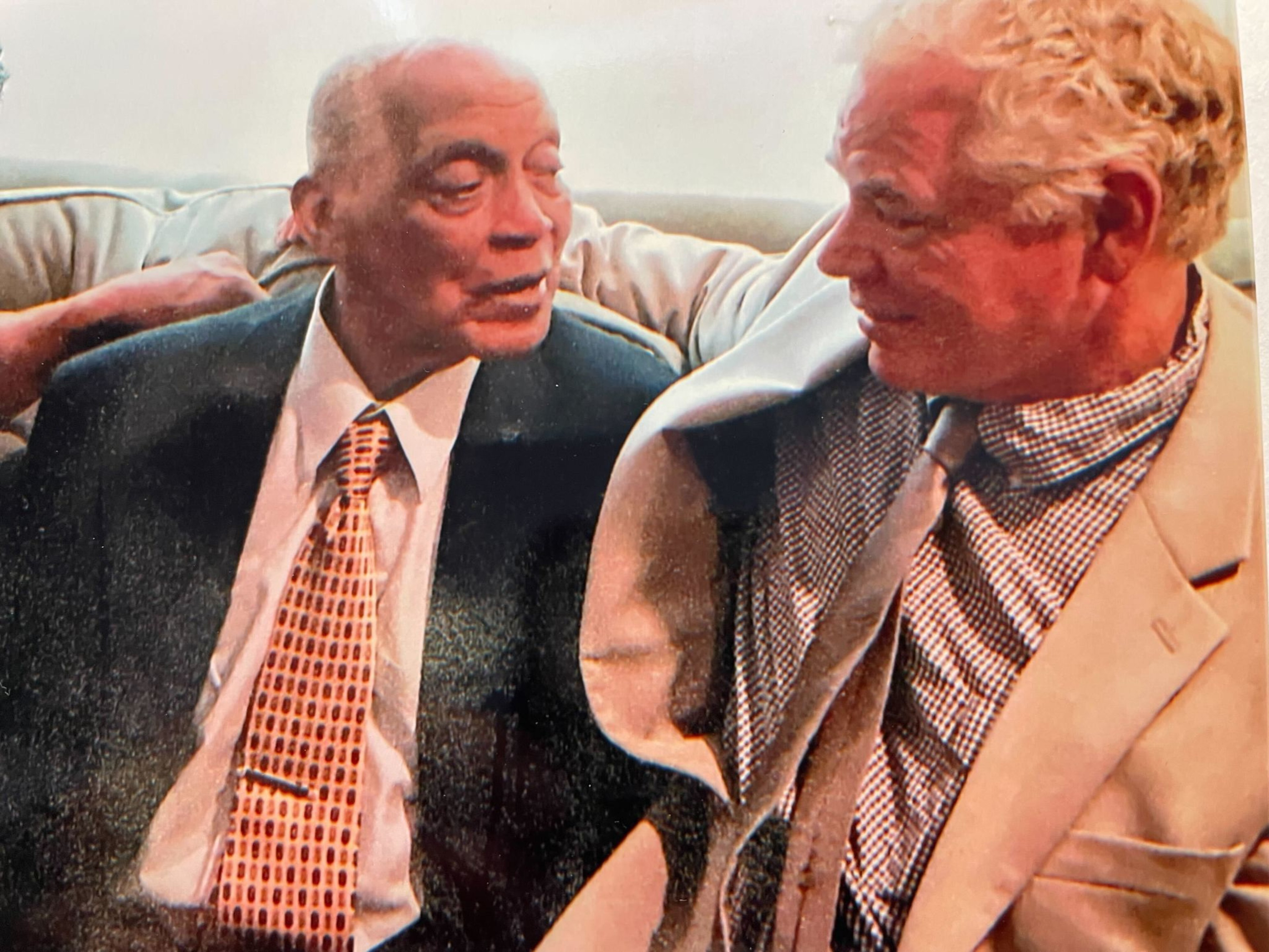 Two men hugging on the couch
