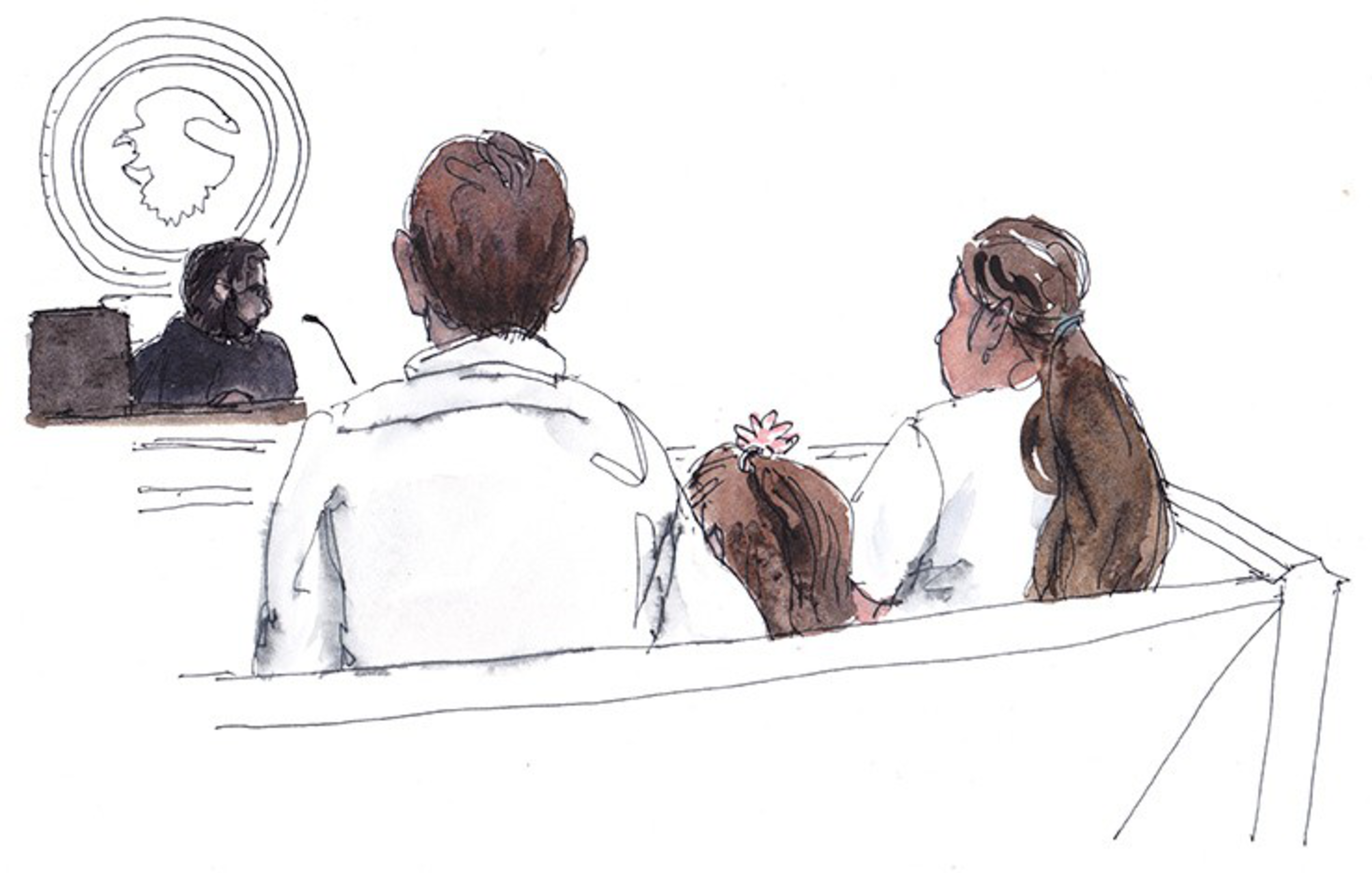 A man, woman, and child with a flower in her hair sit on a bench facing a judge in a courtroom setting.