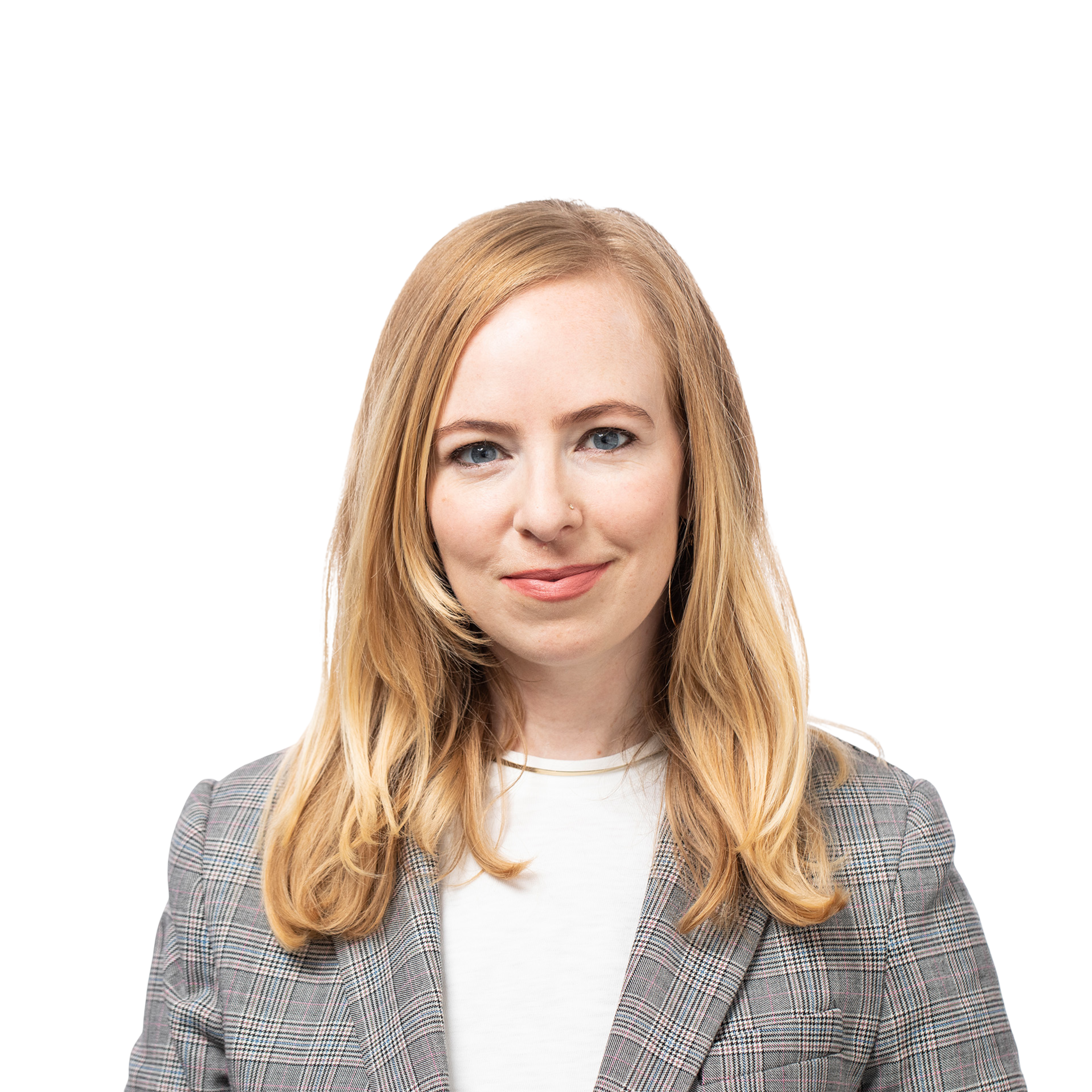 A woman with long blonde hair wears a gray plaid blazer over a white shirt and smiles gently with a neutral, light background.