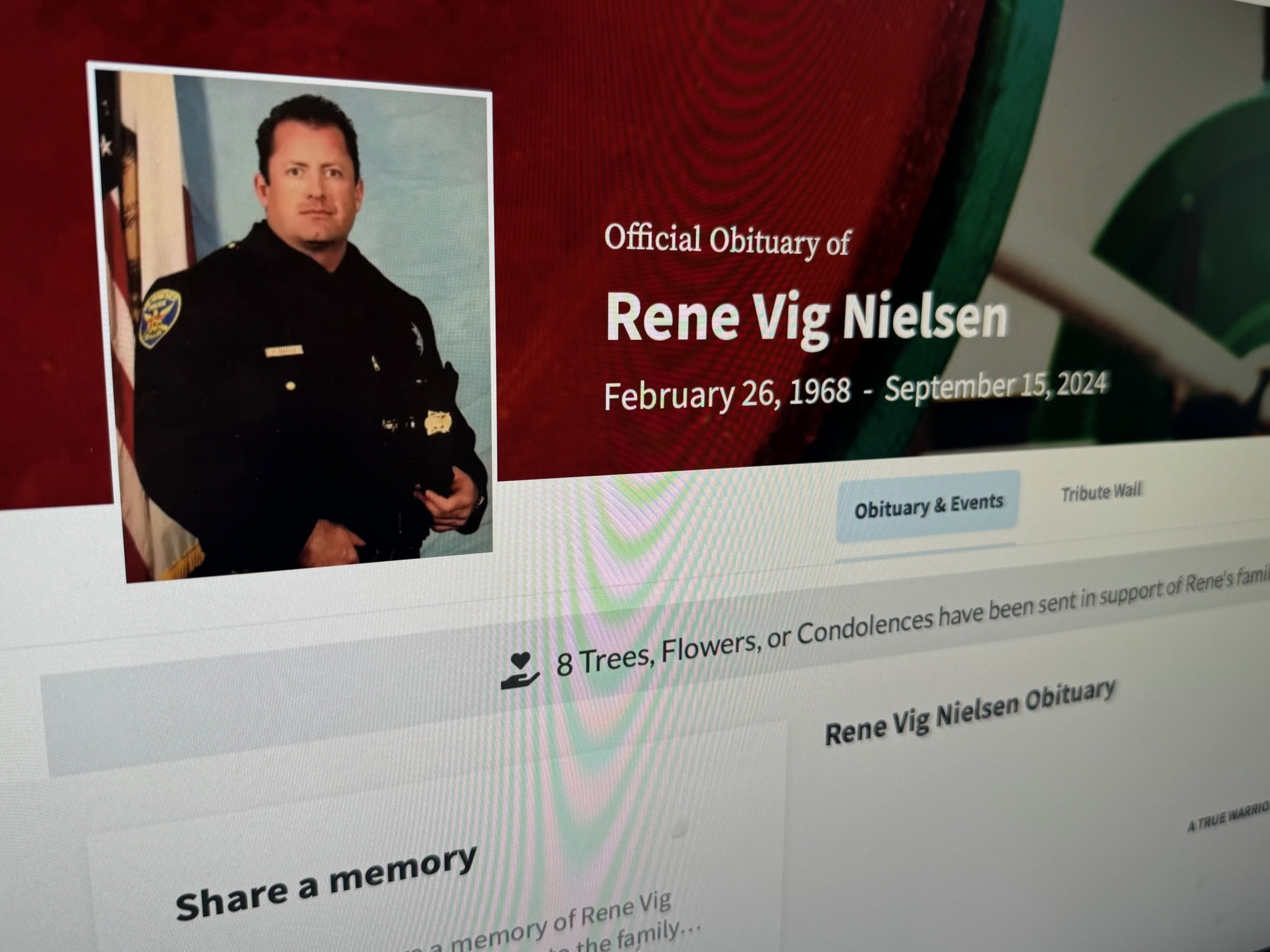 The image shows an obituary page for Rene Vig Nielsen, dated February 26, 1968 - September 15, 2024, featuring a photo of a man in a police uniform.