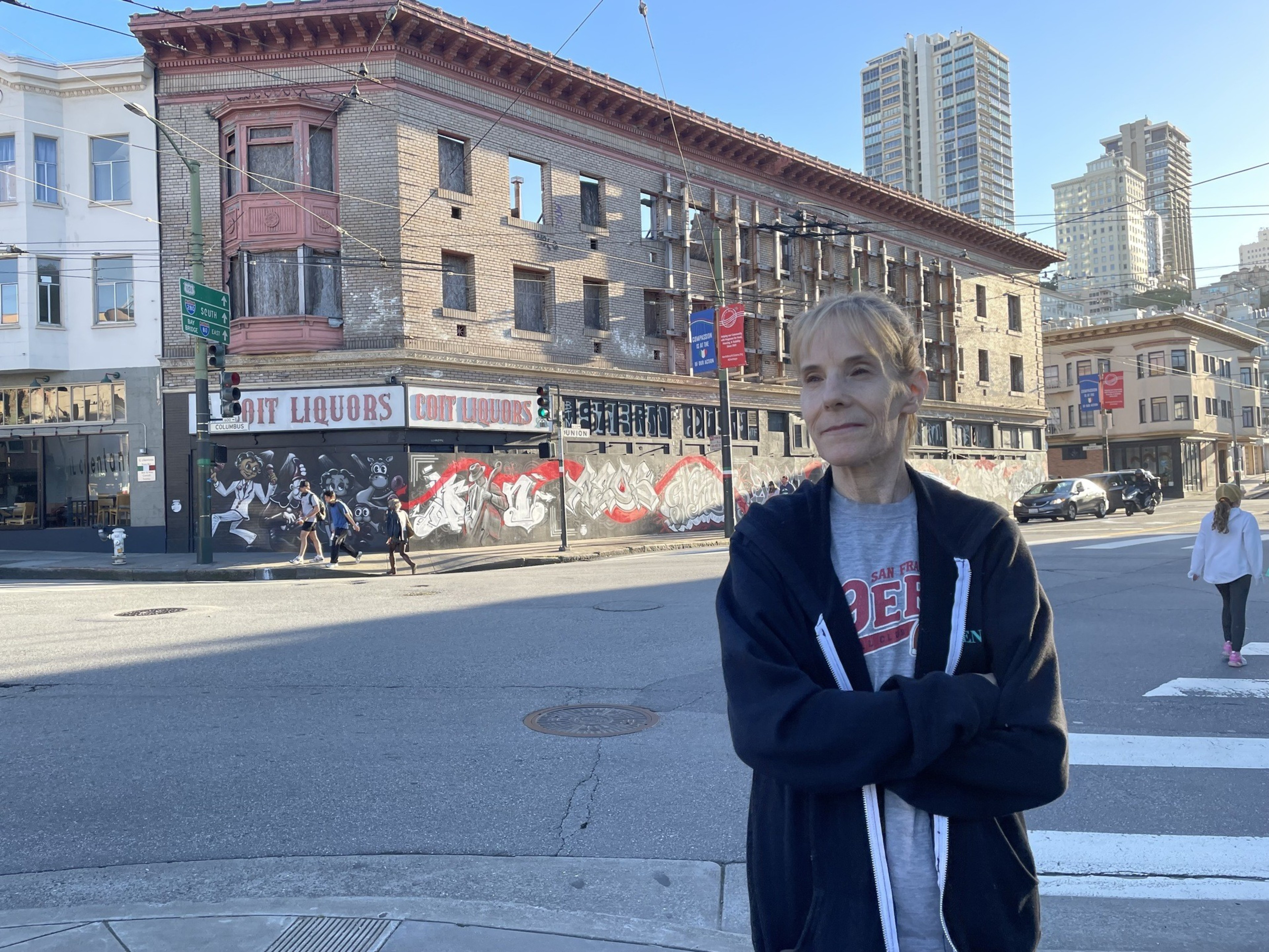 A woman stands on a street.