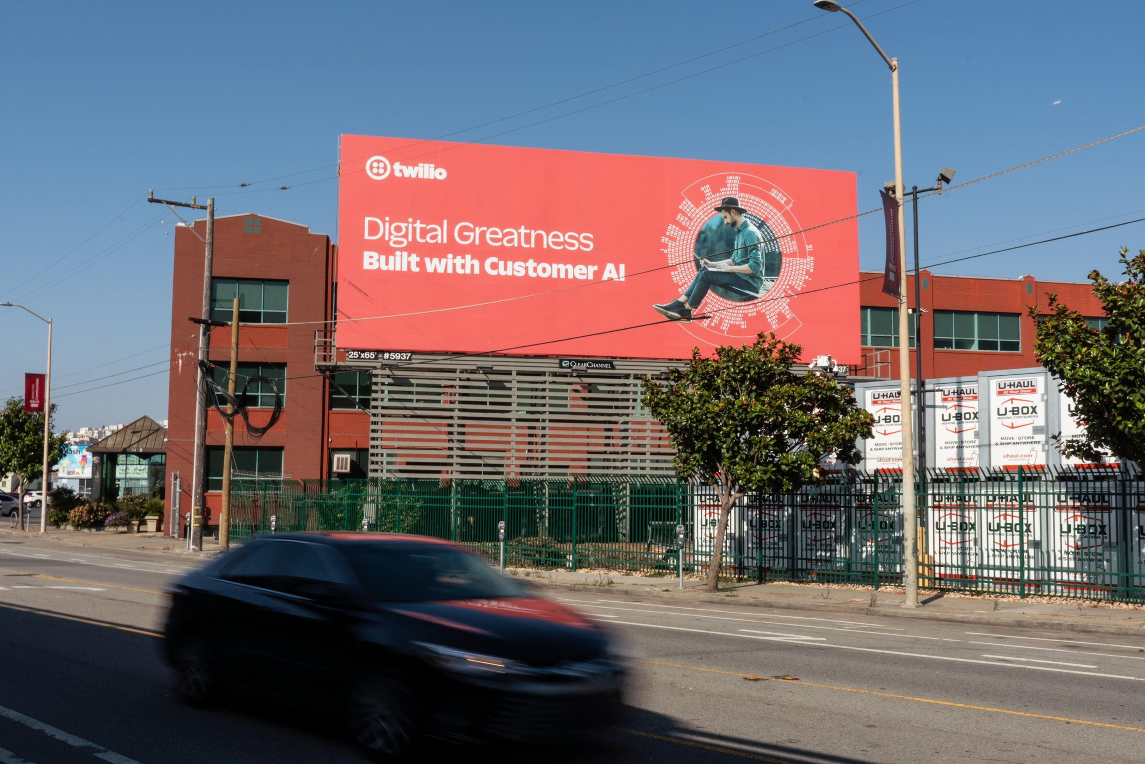 A Twilio billboard is visible from the road as well as from street level in San Francisco