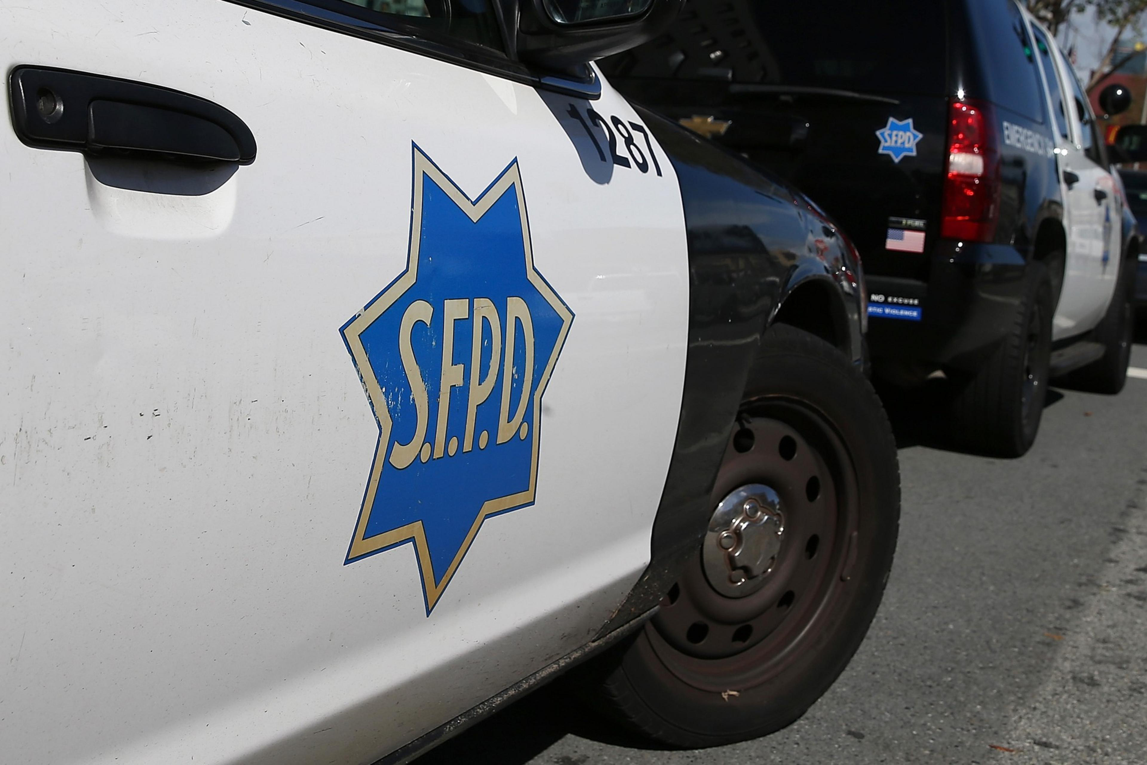 A black and white police vehicle with a San Francisco police star on its door is parked.