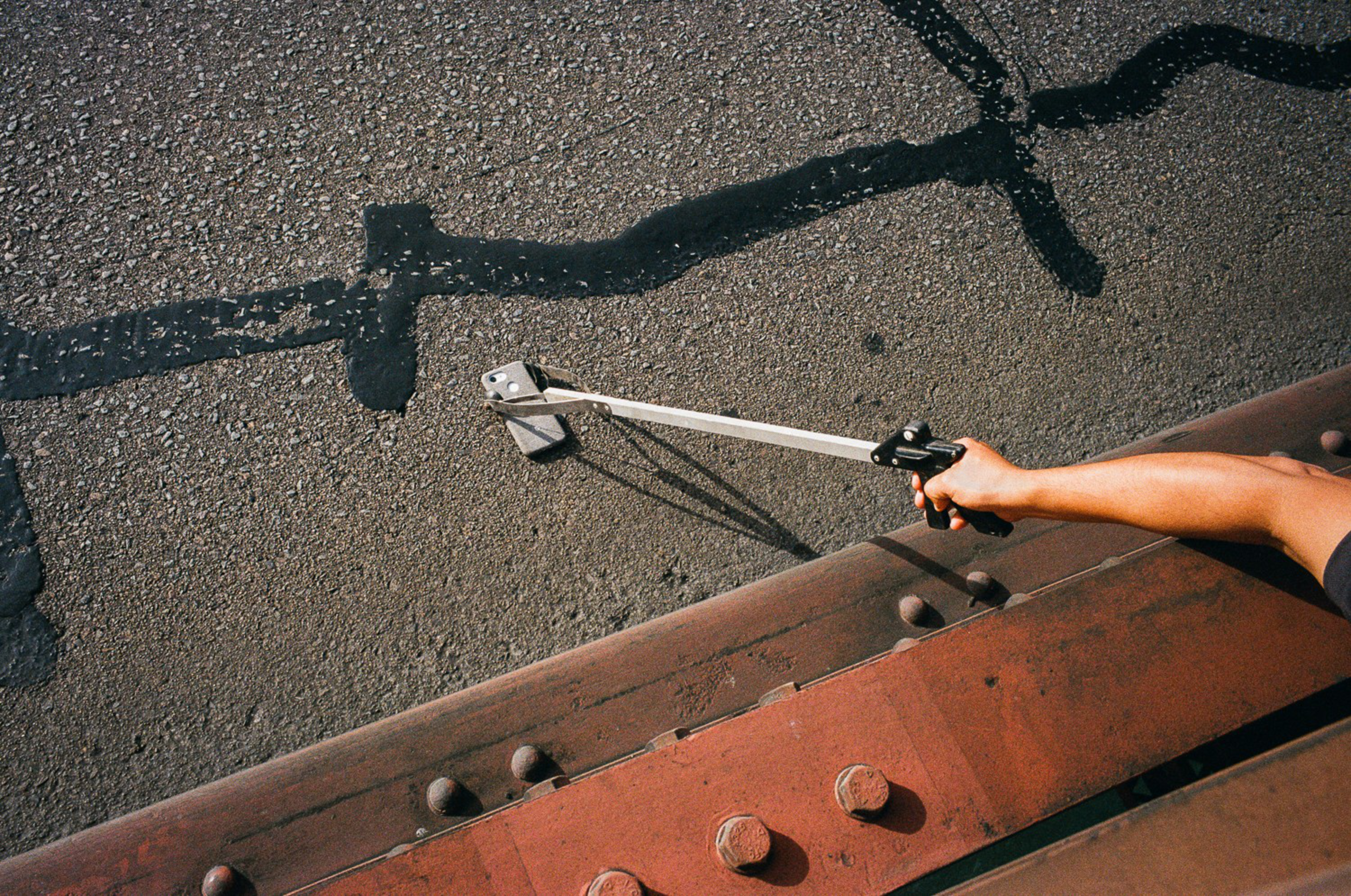 A Bridge Patrol officer retrieves a phone in the roadway for a tourist in August 2019.