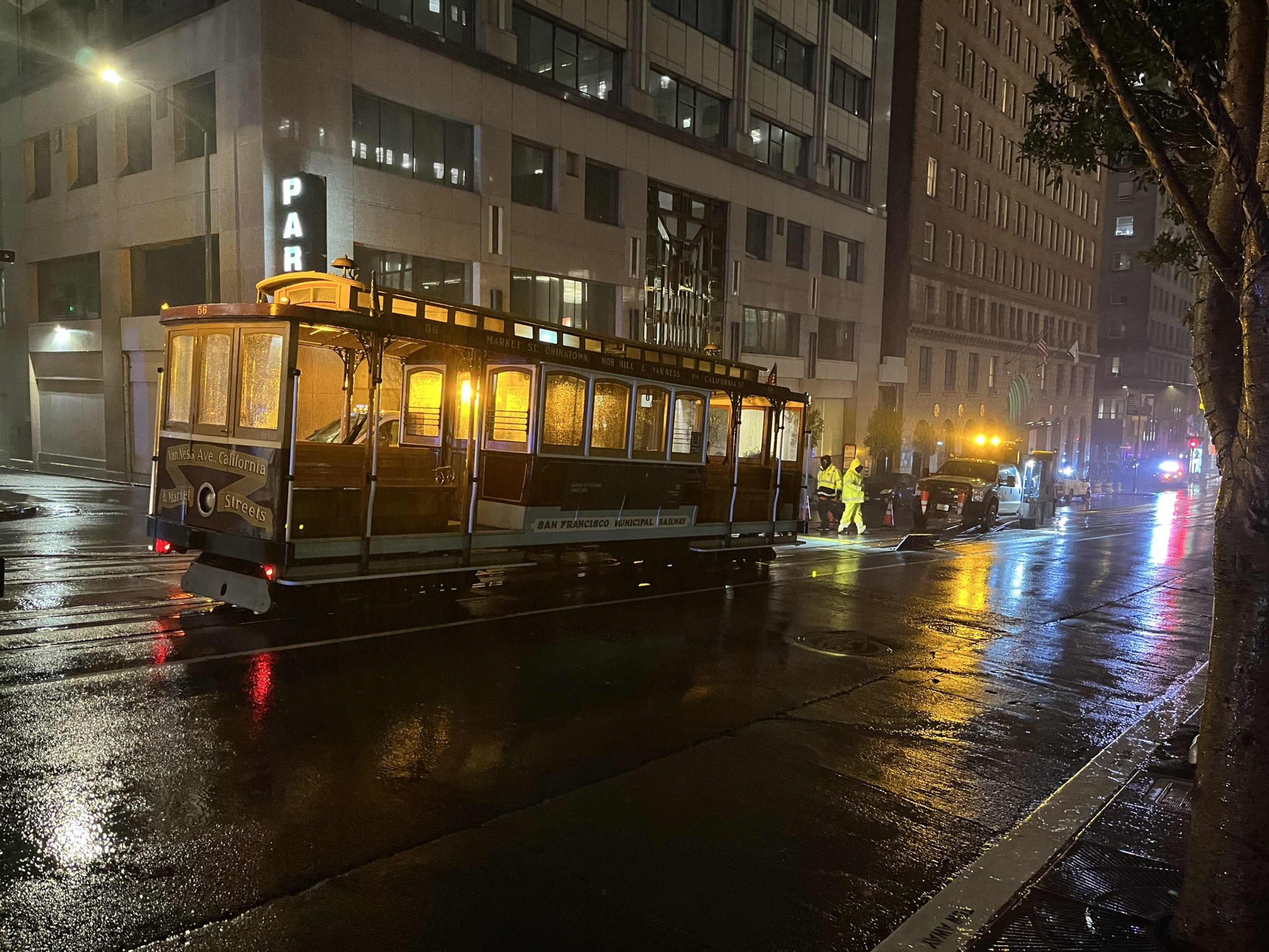 A cable car sits in the middle of a street