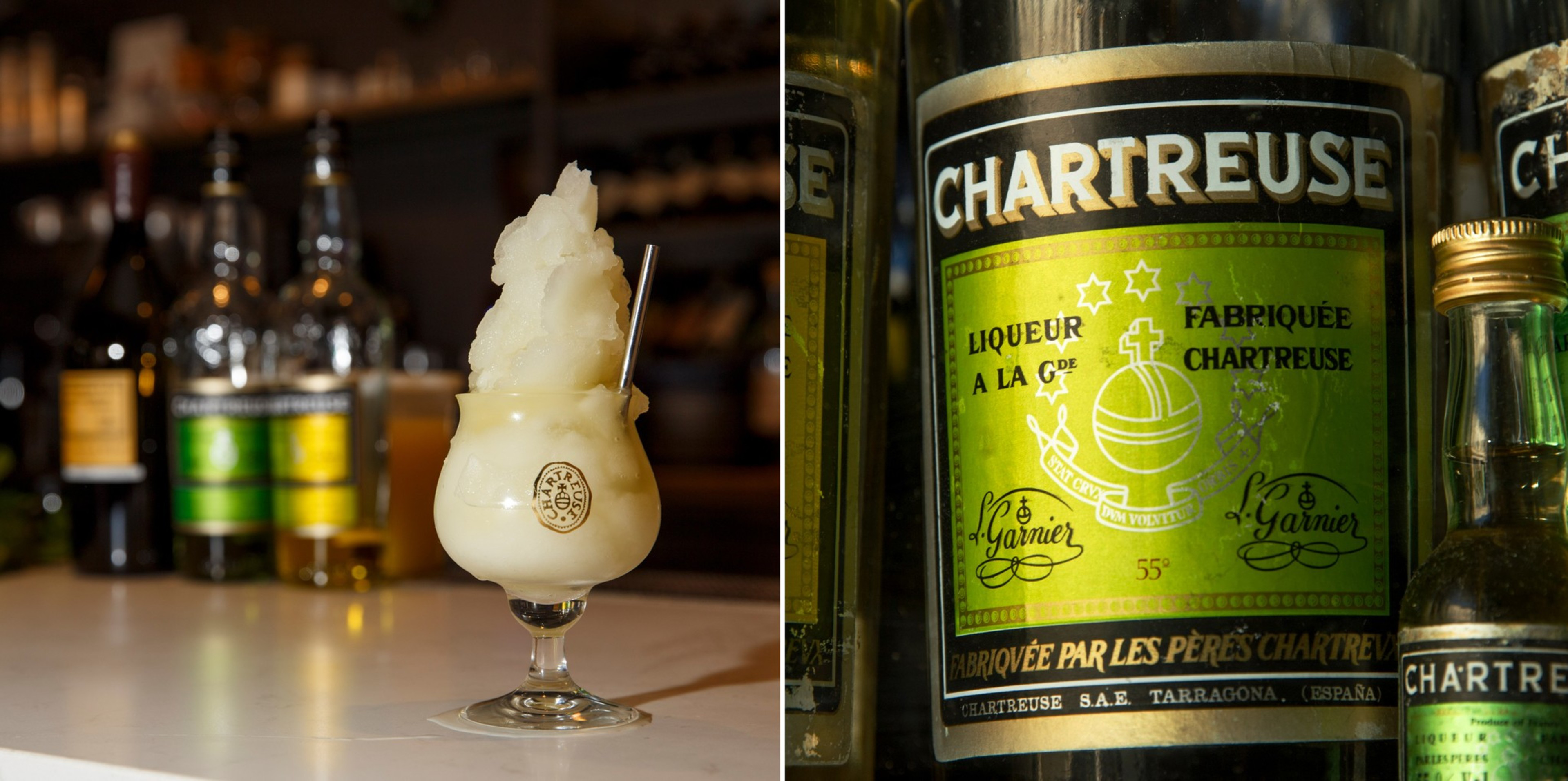 A creamy frozen drink garnished with a spoon sits in front of blurred liquor bottles, including prominently labeled Chartreuse bottles.