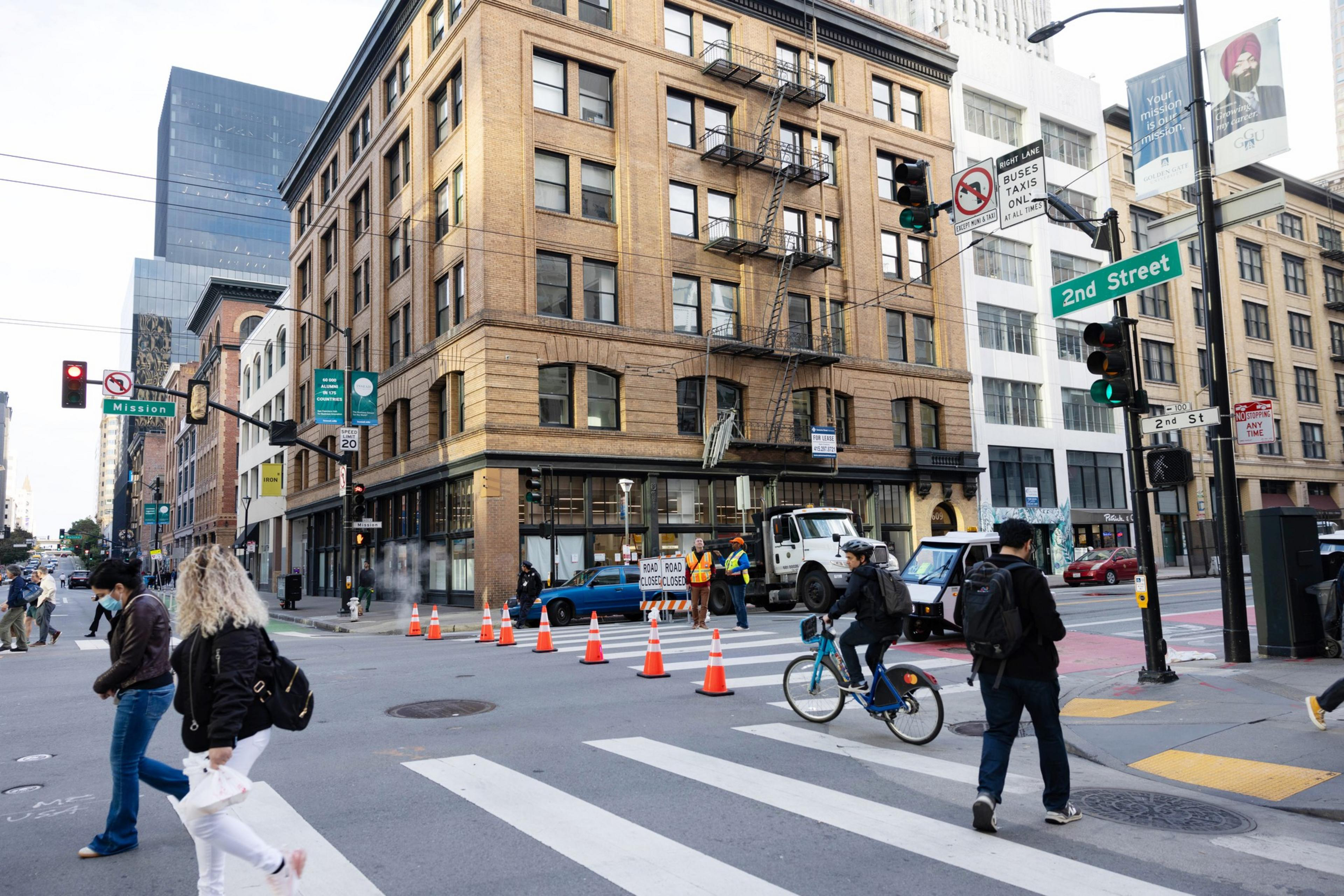 Pedestrians cross the intersection at Mission and 2nd St.